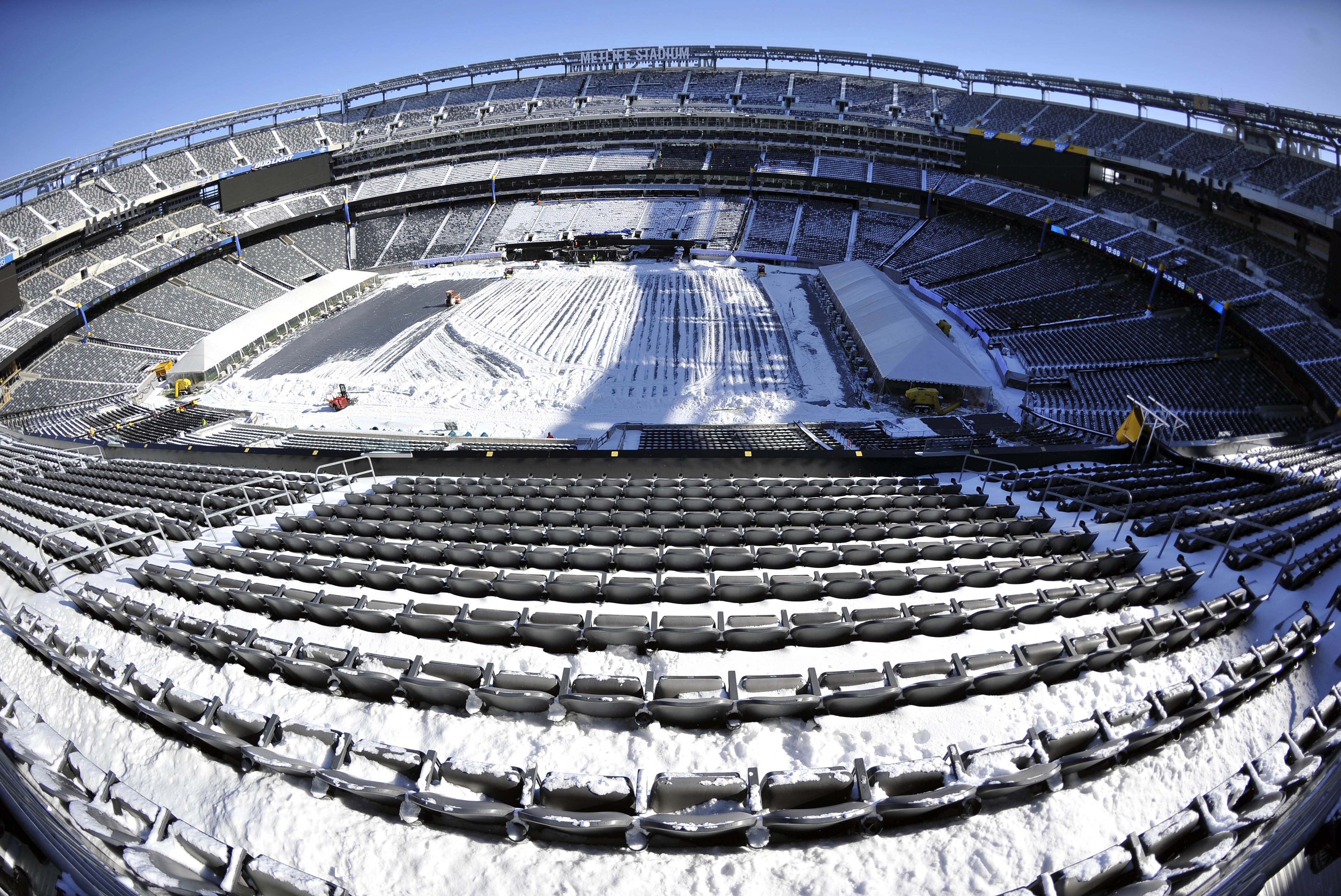 Jan 22, 2014; East Rutherford, NJ, USA; A general view as stadium workers clean snow from the field and stands during the Super Bowl XLVIII stadium preparations press conference at MetLife Stadium. Mandatory Credit: Joe Camporeale-USA TODAY Sports