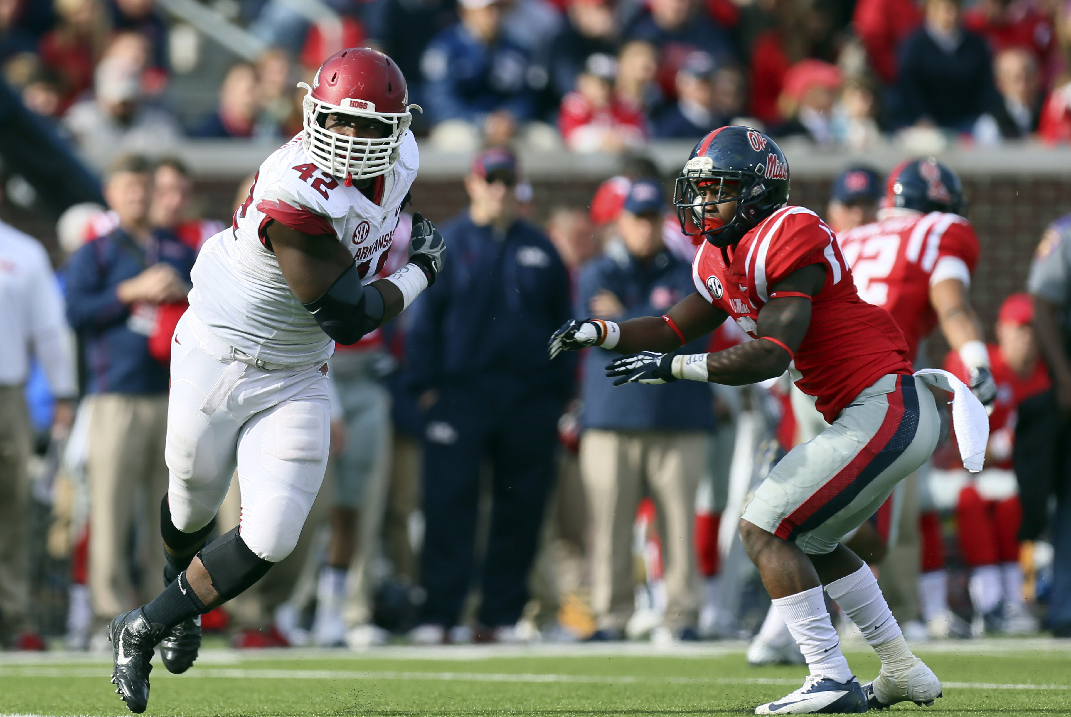 Nov 9, 2013; Oxford, MS, USA; Arkansas Razorbacks defensive end Chris Smith (42) breaks through the block of Mississippi Rebels defensive back Cliff Coleman (6) during the game at Vaught-Hemingway Stadium. Mississippi Rebels defeat the Arkansas Razorbacks with a score of 34-24.  Mandatory Credit: Spruce Derden-USA TODAY Sports