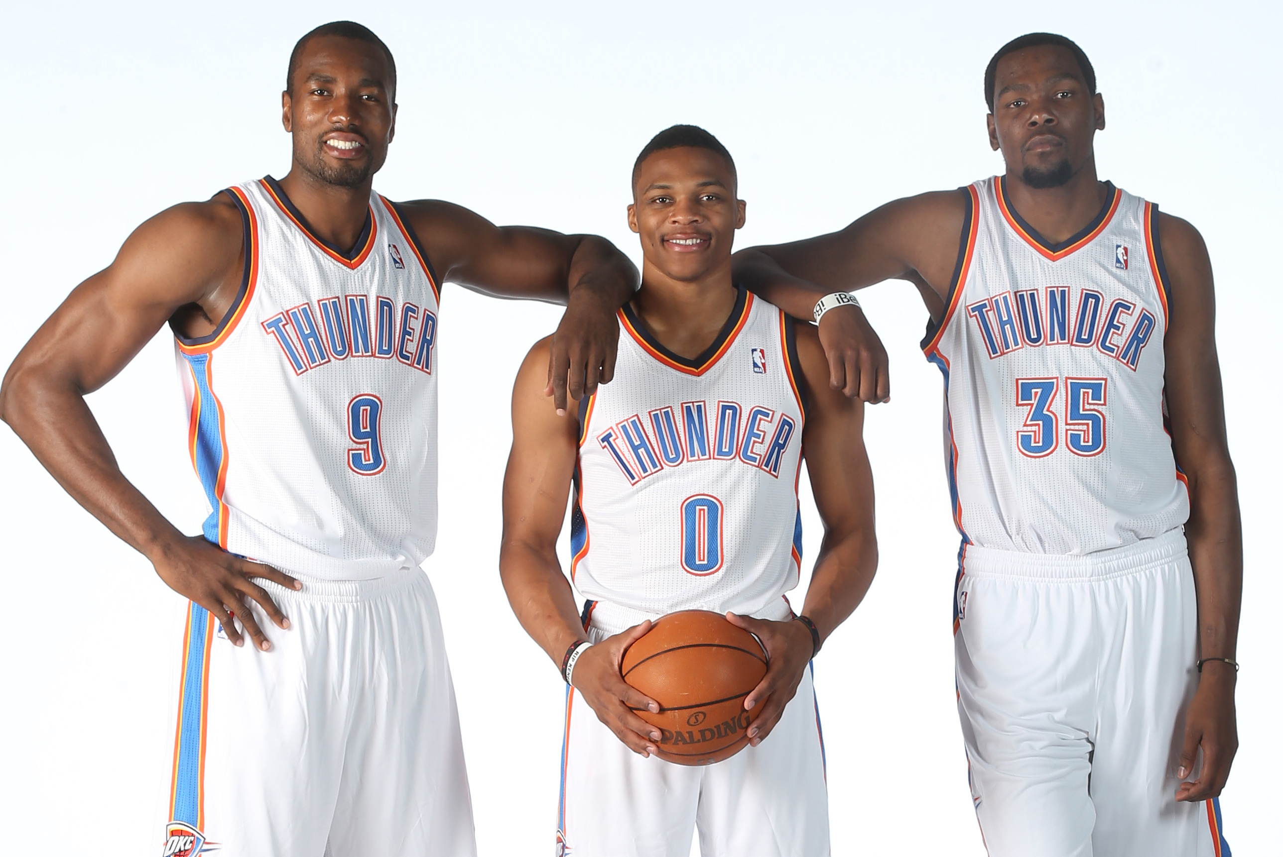 EDMOND, OK - SEPTEMBER 27: (LtoR) Serge Ibaka #9, Russell Westbrook #0, and Kevin Durant #35 poses for a portrait during 2013 NBA Media Day on September 27, 2013 at the Thunder Events Center in Edmond, Oklahoma. NOTE TO USER: User expressly acknowledges and agrees that, by downloading and or using this Photograph, user is consenting to the terms and conditions of the Getty Images License Agreement. Mandatory Copyright Notice: Copyright 2013 NBAE (Photo by Layne Murdoch/NBAE via Getty Images)