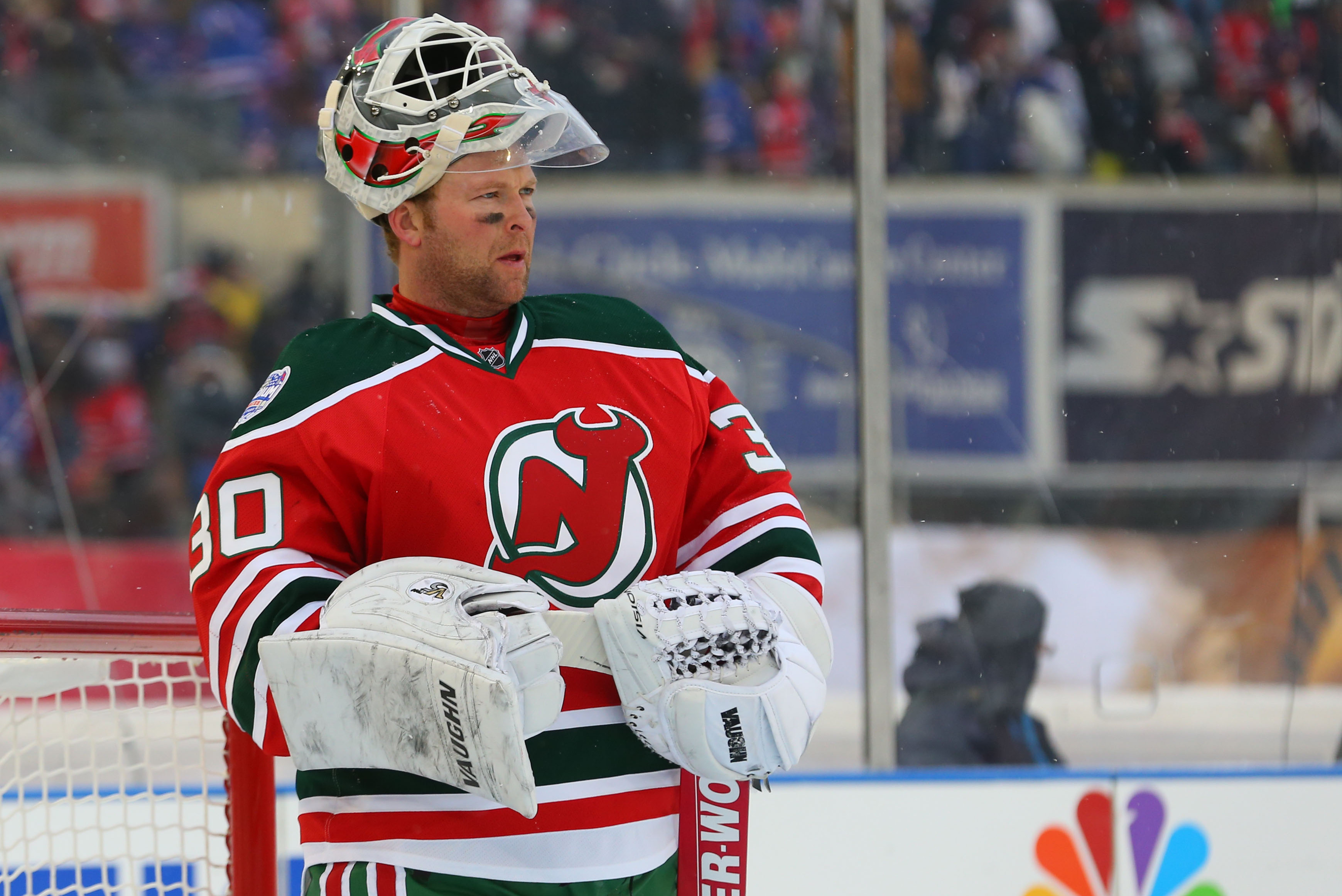 Jan 26, 2014; New York City, NY, USA; New Jersey Devils goalie Martin Brodeur (30) reacts during a stoppage in play during the second period of the Stadium Series hockey game against the New York Rangers at Yankee Stadium. Mandatory Credit: Ed Mulholland-USA TODAY Sports