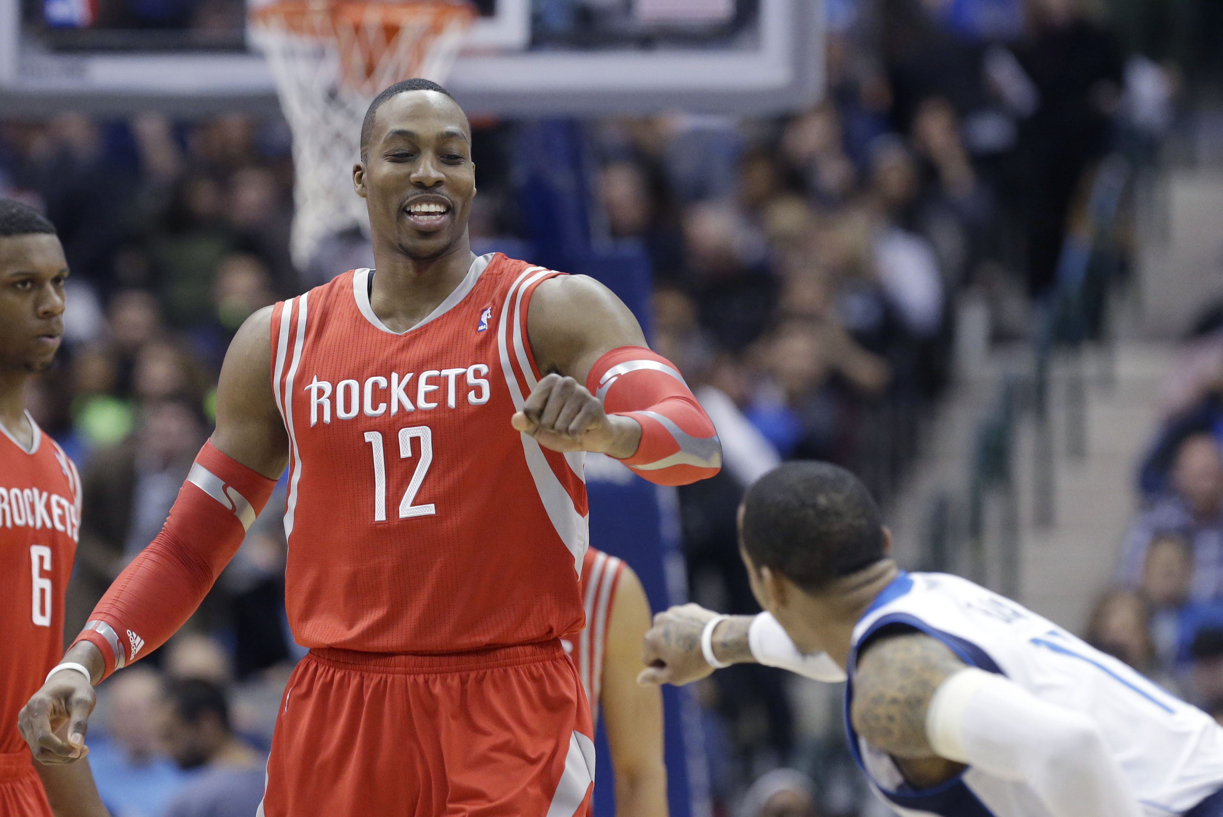 Houston Rockets center Dwight Howard (12) greets Dallas Mavericks shooting guard Monta Ellis (11) before the start of their NBA basketball game Wednesday, Jan. 29, 2014, in Dallas. (AP Photo/LM Otero)