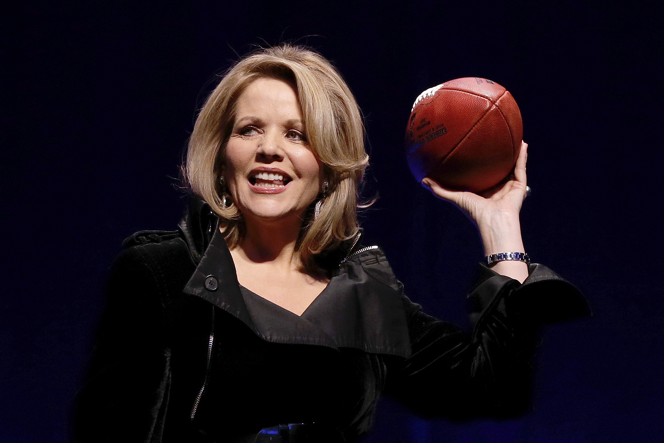 Opera singer Renee Fleming who will sing the National Anthem before the NFL Super Bowl XLVIII football game holds the game ball during a press conference Thursday, Jan. 30, 2014, in New York. (AP Photo)