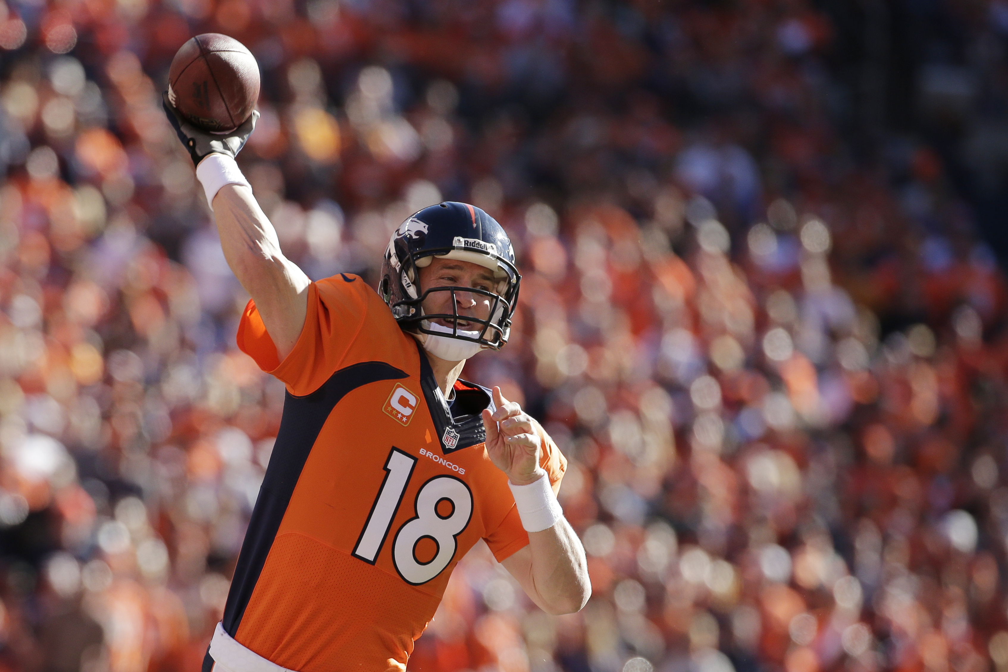 Denver Broncos quarterback Peyton Manning (18)passes the ball during the first half of the AFC Championship NFL playoff football game against the New England Patriots in Denver, Sunday, Jan. 19, 2014. (AP Photo/Charlie Riedel)