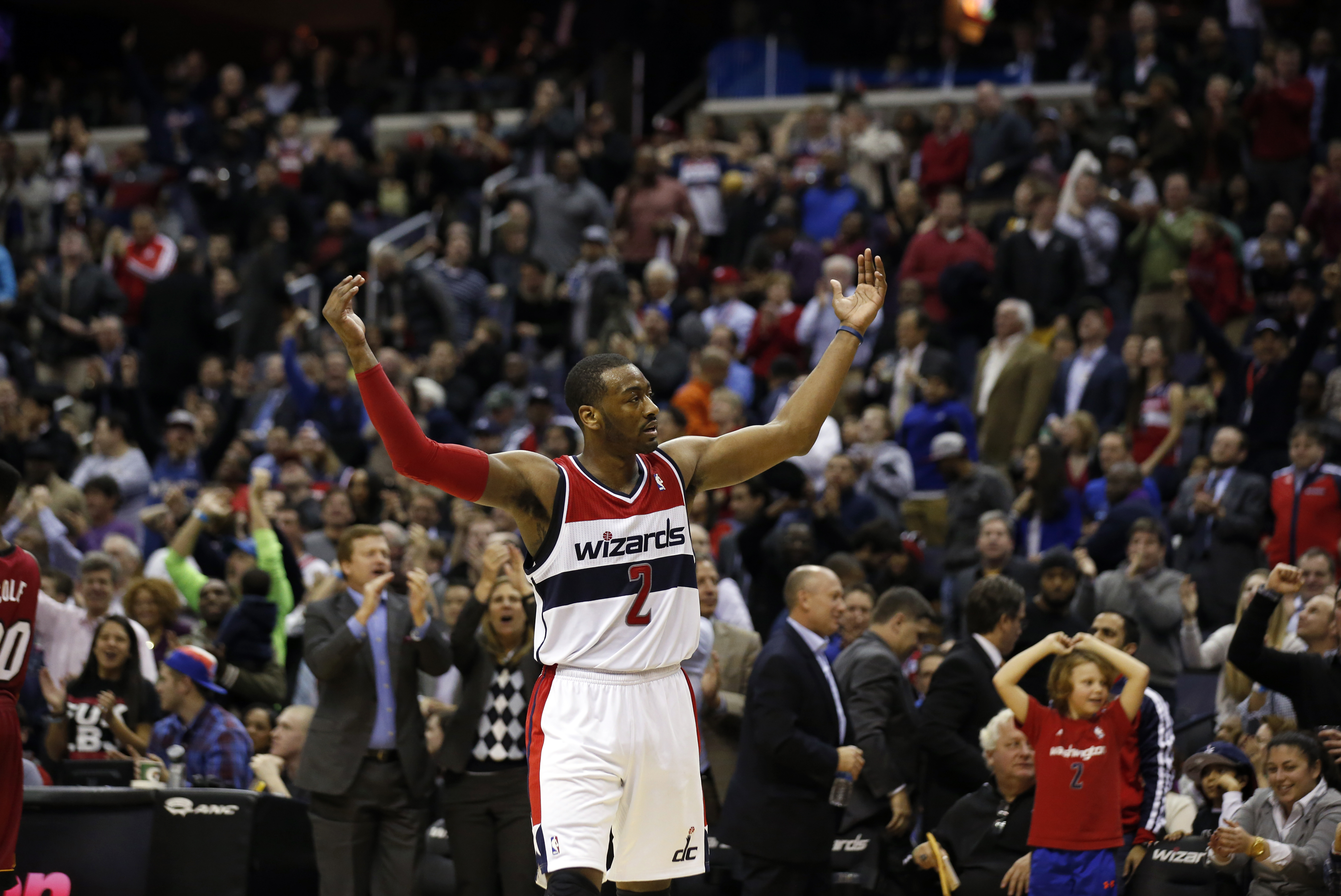 Washington Wizards guard John Wall (2) celebrates in the second half of an NBA basketball game against the Miami Heat, Wednesday, Jan. 15, 2014, in Washington. The Wizards won 114-97. (AP Photo/Alex Brandon)