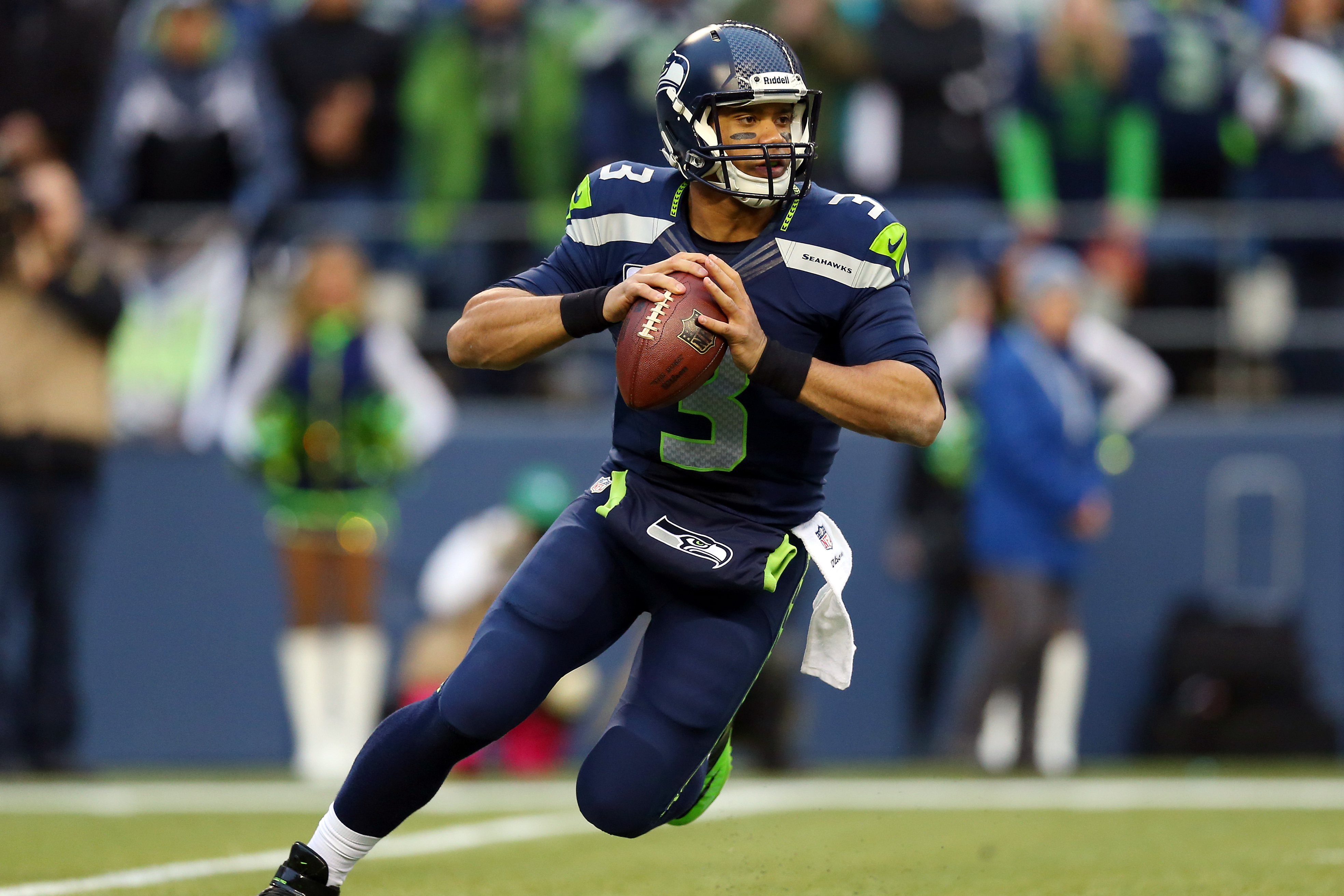 SEATTLE, WA - JANUARY 19:  Quarterback Russell Wilson #3 of the Seattle Seahawks drops back against the San Francisco 49ers during the 2014 NFC Championship at CenturyLink Field on January 19, 2014 in Seattle, Washington.  (Photo by Ronald Martinez/Getty Images)