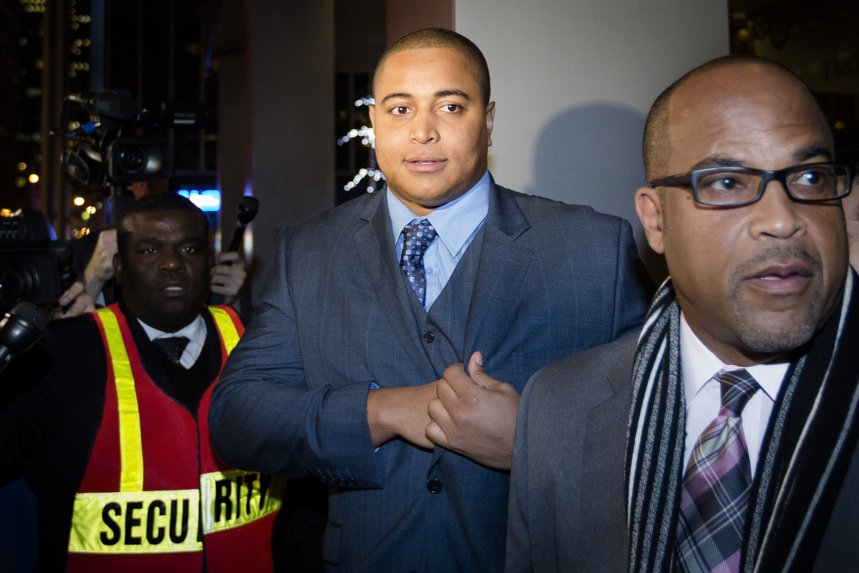 Miami Dolphins lineman Jonathan Martin, center, prepares to speak to members of the media outside the office of the NFL lawyer investigating the team's bullying scandal, Friday, Nov. 15, 2013, in New York. The league is trying to gather information about the harassment Martin says he was subjected to by teammate Richie Incognito. (AP Photo/John Minchillo)
