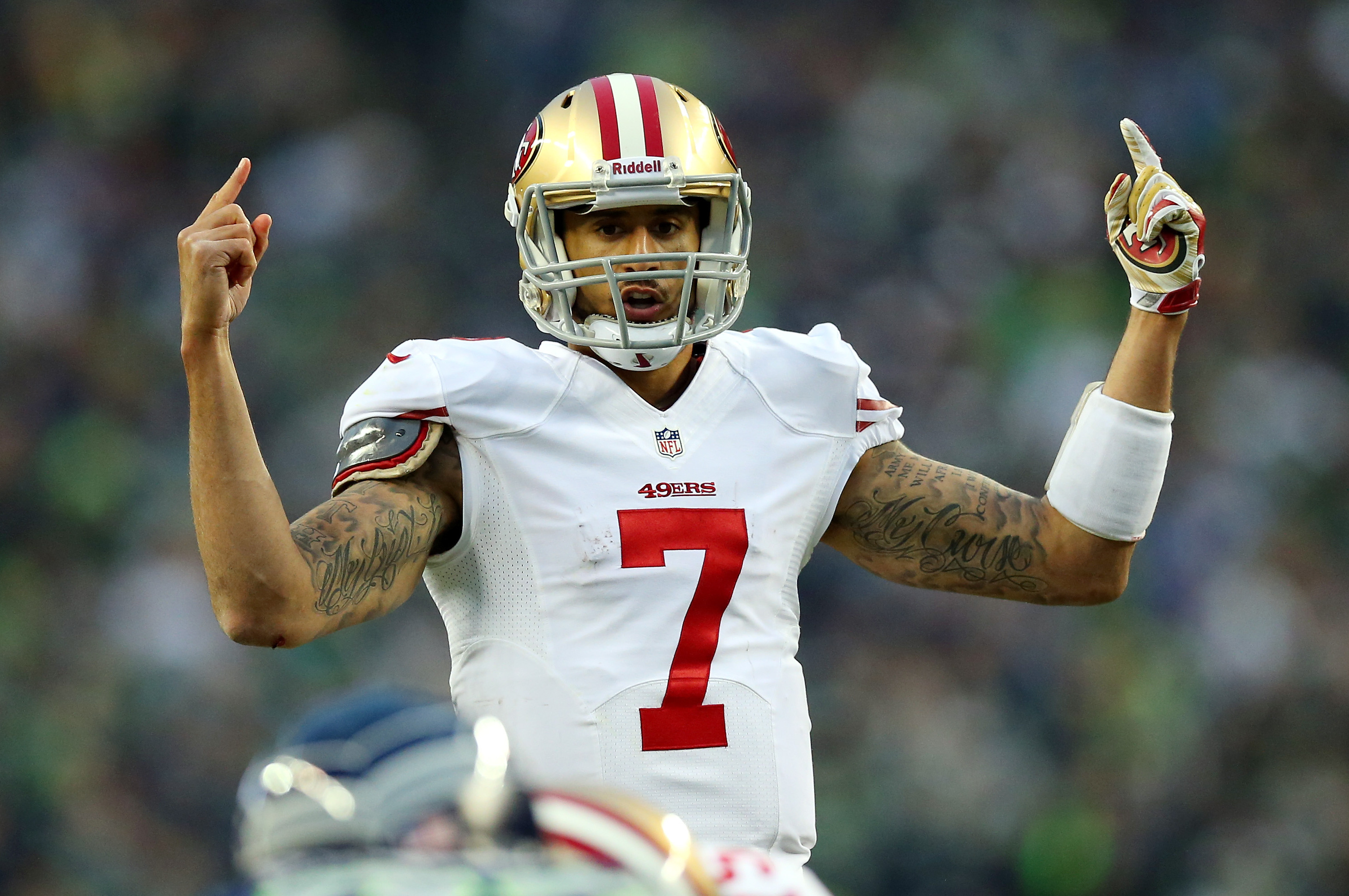 SEATTLE, WA - JANUARY 19:  Quarterback Colin Kaepernick #7 of the San Francisco 49ers calls a play against the Seattle Seahawks during the 2014 NFC Championship at CenturyLink Field on January 19, 2014 in Seattle, Washington.  (Photo by Ronald Martinez/Getty Images)
