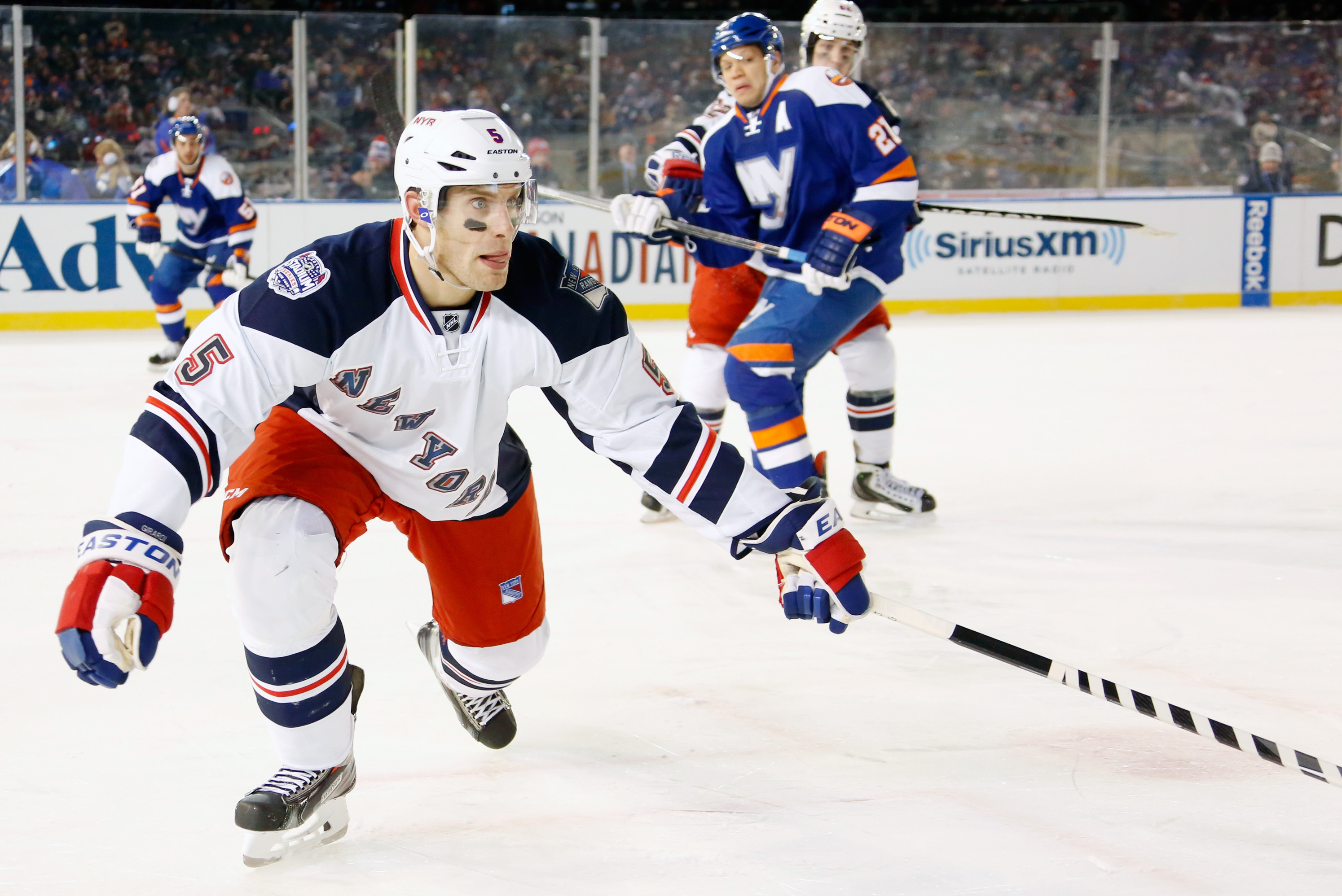 NEW YORK, NY - JANUARY 29:  (EDITORIAL USE ONLY) Dan Girardi #5 of the New York Rangers skates against the New York Islanders during the 2014 Coors Light NHL Stadium Series at Yankee Stadium on January 29, 2014 in the Bronx borough of New York City. (Photo by Scott Levy/NHLI via Getty Images)