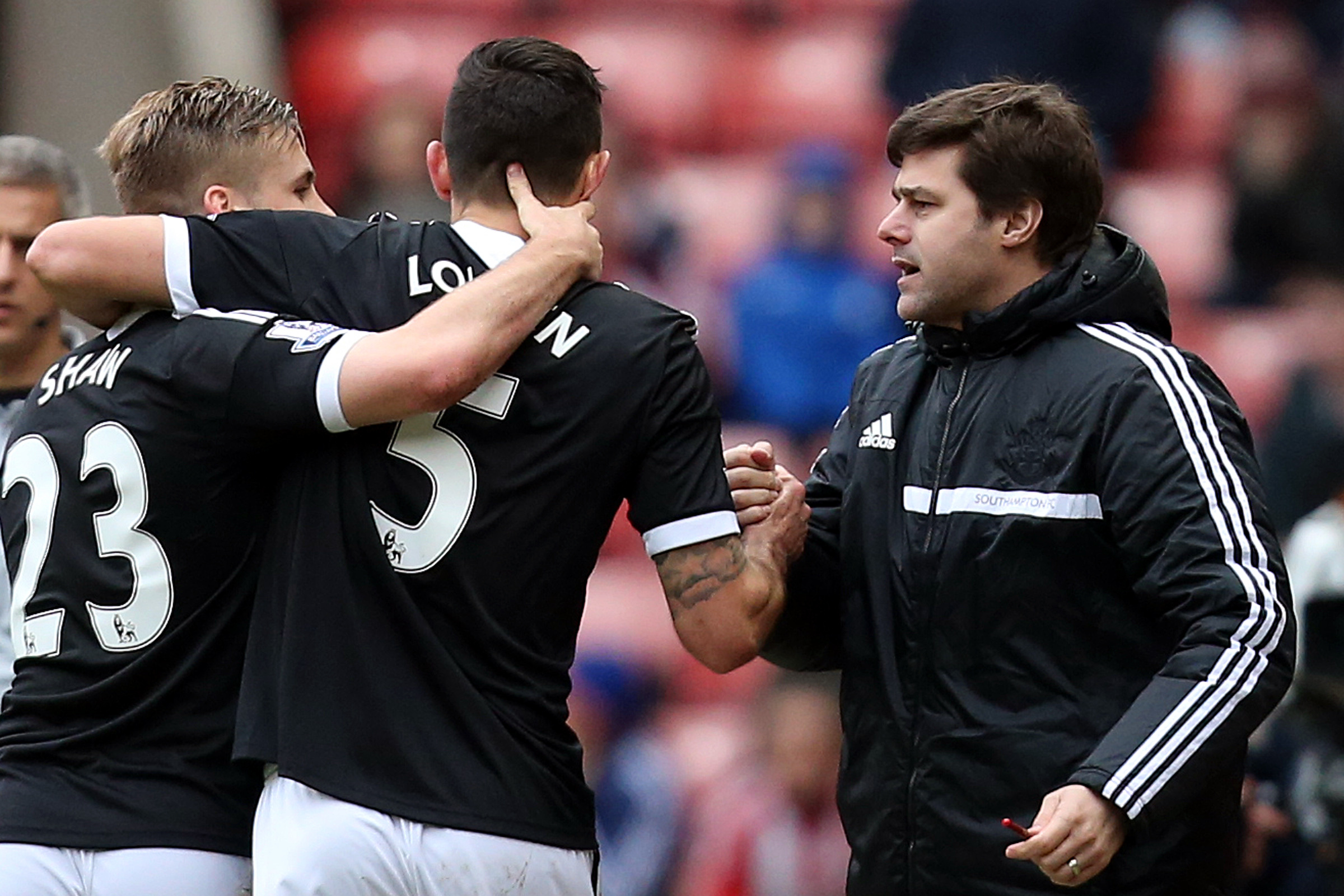 Southampton's Dejan Lovren, center, celebrates his goal with manager Mauricio Pochettino, right, during their English Premier League soccer match against Sunderland at the Stadium of Light, Sunderland, England, Saturday, Jan. 18, 2014. (AP Photo/Scott Heppell)