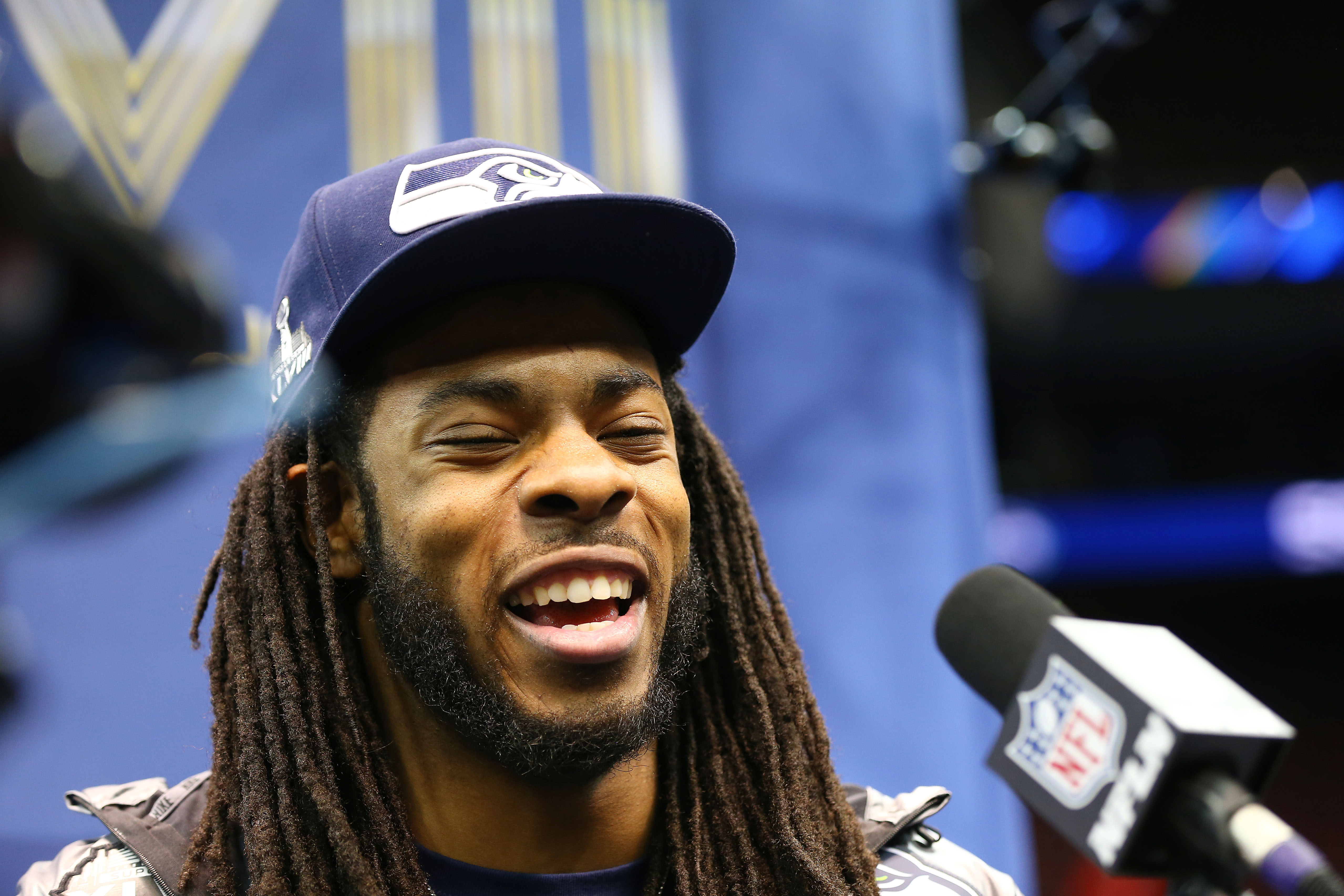 NEWARK, NJ - JANUARY 28:  Cornerback Richard Sherman #25 of the Seattle Seahawks speaks to the media during Super Bowl XLVIII Media Day at the Prudential Center on January 28, 2014 in Newark, New Jersey.  Super Bowl XLVIII will be played between the Seattle Seahawks and the Denver Broncos on February 2.  (Photo by Elsa/Getty Images)