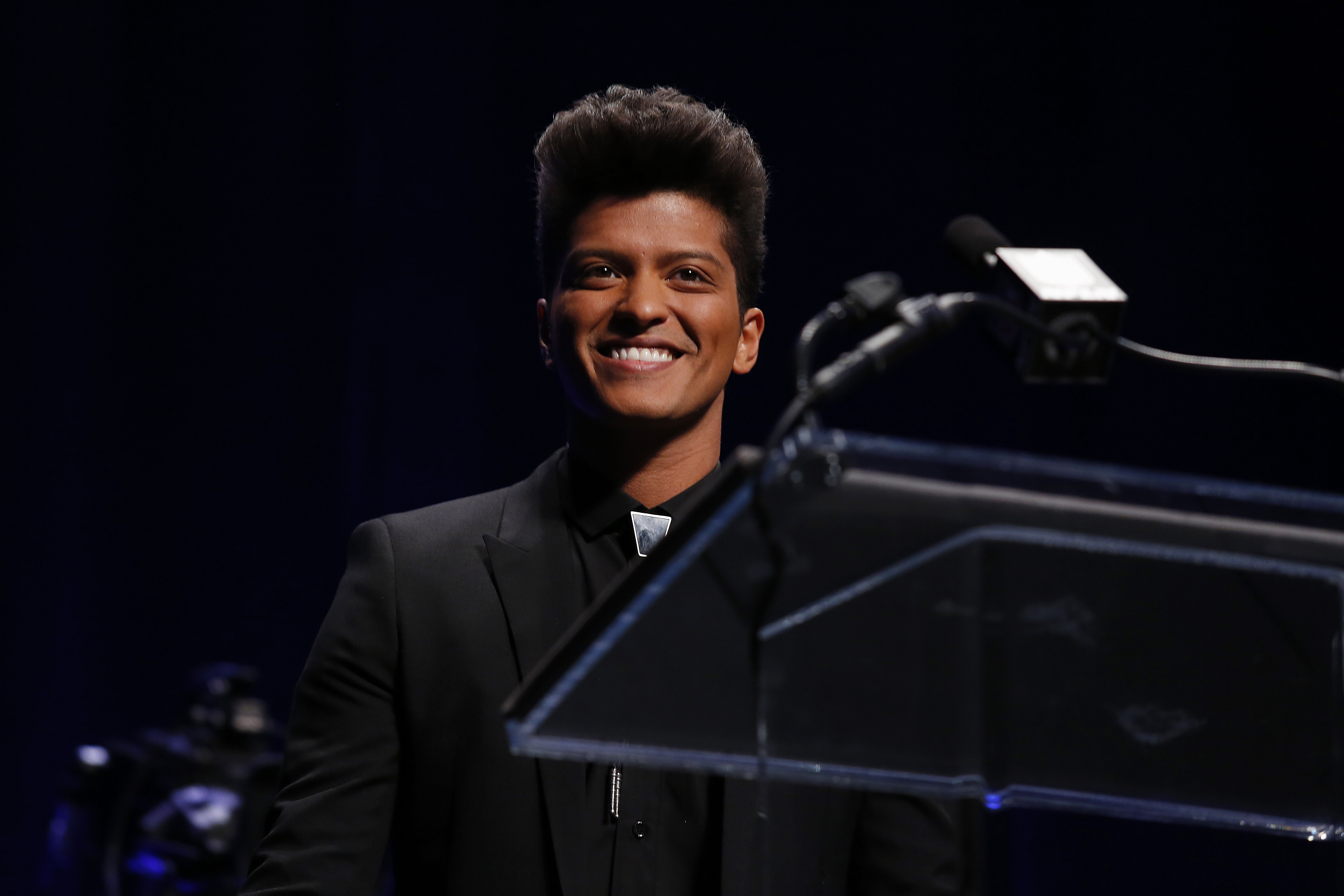 Singer Bruno Mars speaks during a press conference to discuss his performance during the Super Bowl XLVIII halftime show, Thursday, Jan. 30, 2014, in New York. (AP Photo/Doug Benc)