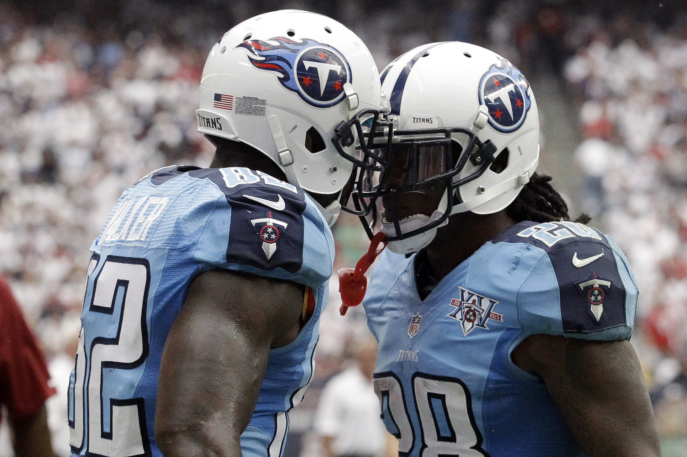 Tennessee Titans' Delanie Walker, left, celebrates with teammate Chris Johnson, right, after scoring a touchdown against the Houston Texans during the fourth quarter of an NFL football game on Sunday, Sept. 15, 2013, in Houston. (AP Photo/Patric Schneider)