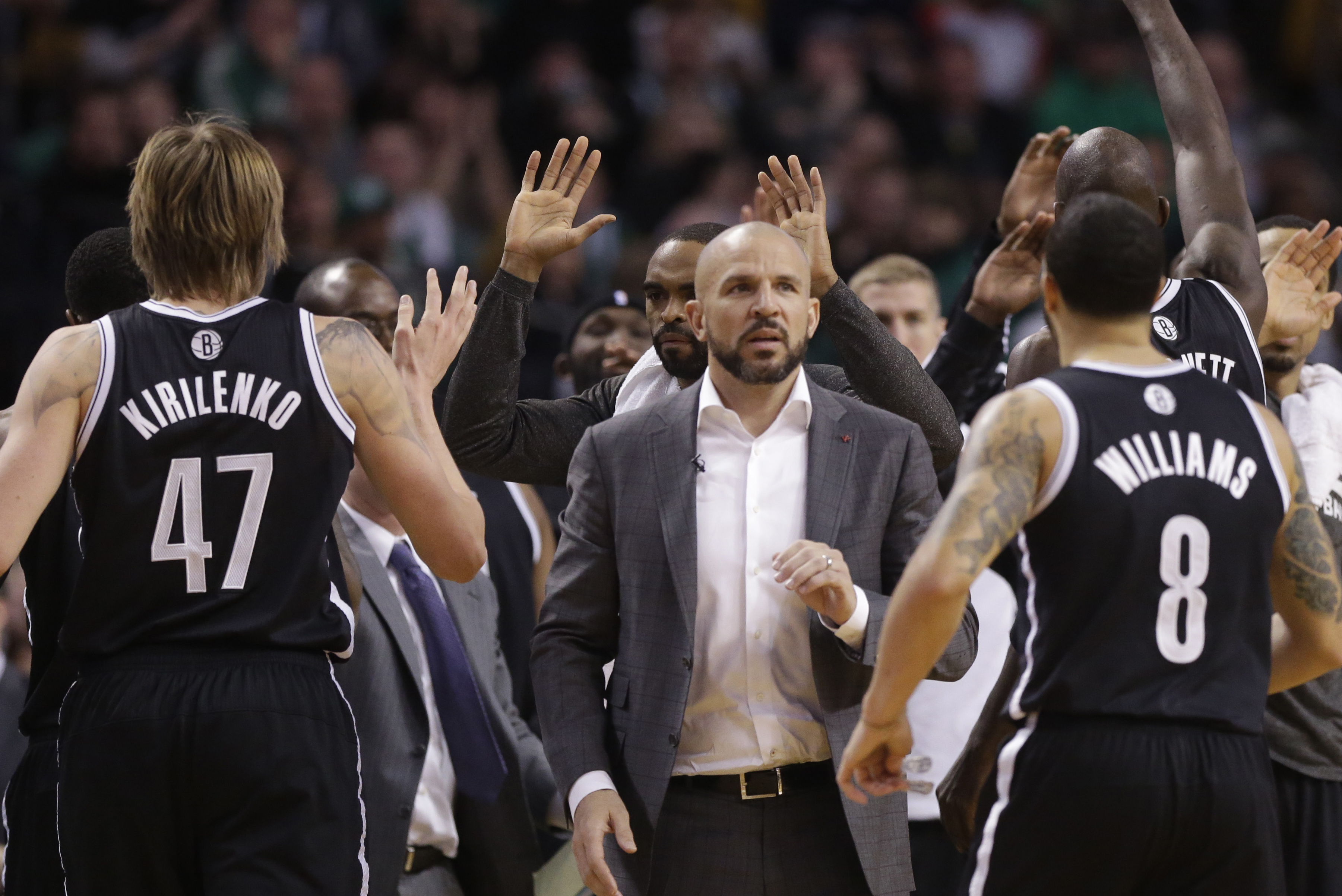 Brooklyn Nets head coach Jason Kidd celebrates with members of the team in the fourth quarter of an NBA basketball game against the Boston Celtics Sunday, Jan. 26, 2014, in Boston. The Nets won 85-79. (AP Photo/Steven Senne)