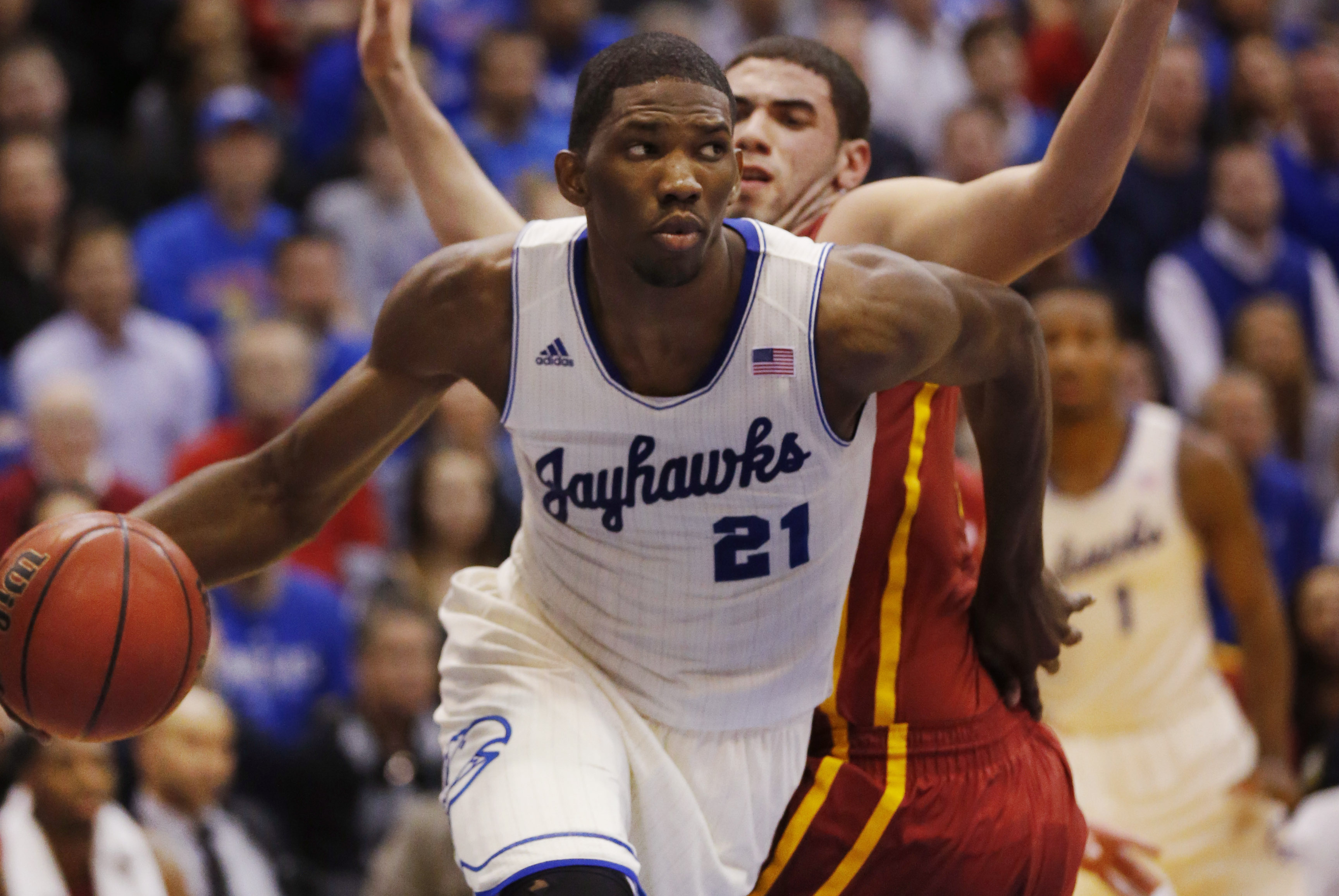 Kansas center Joel Embiid (21) works around Iowa State forward Georges Niang, back, during the first half of an NCAA college basketball game in Lawrence, Kan., Wednesday, Jan. 29, 2014. Kansas won 92-81. (AP Photo/Orlin Wagner)