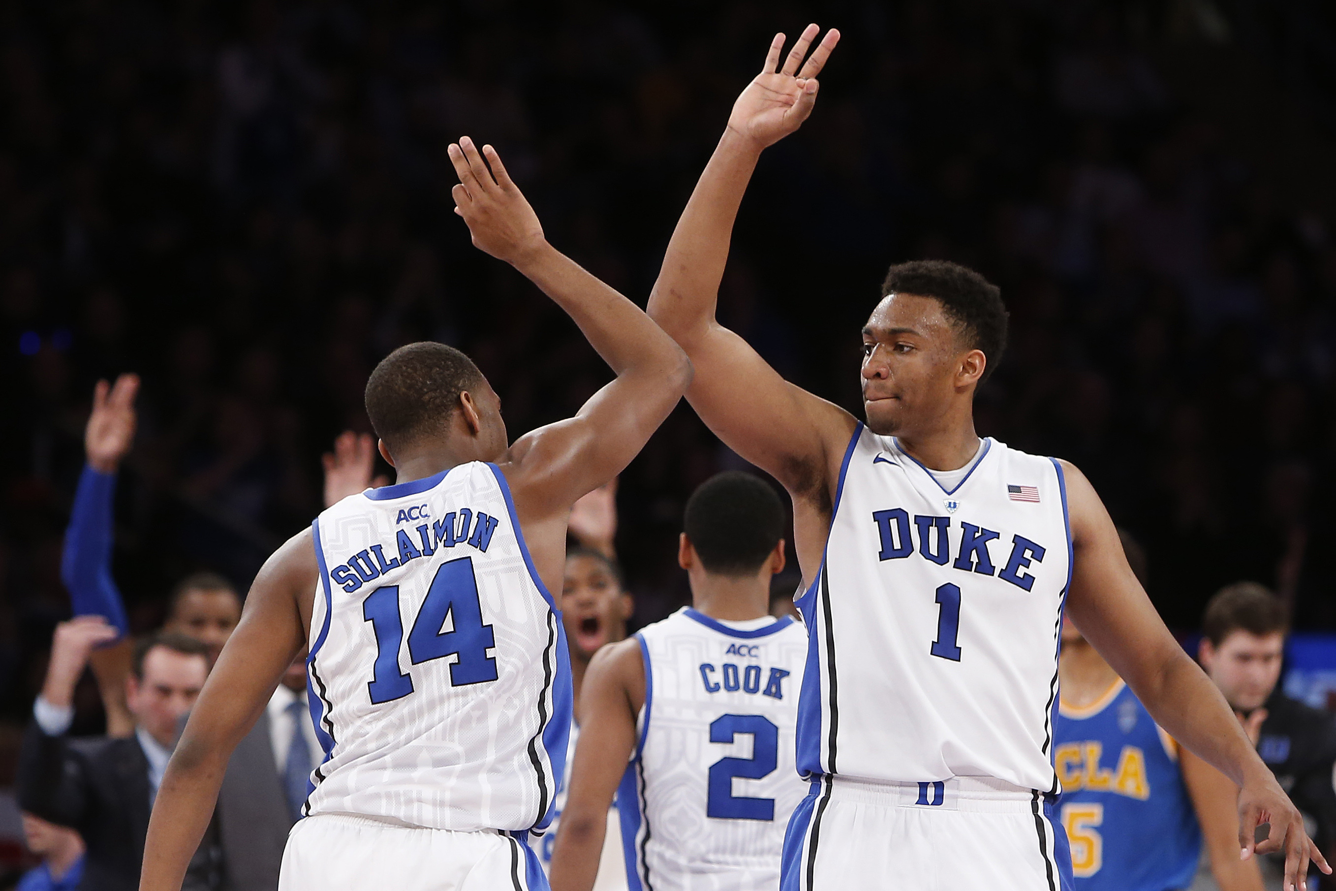 Duke's Jabari Parker (1) celebrates with teammate Rasheed Sulaimon (14) during the second half of an NCAA college basketball game against UCLA Thursday, Dec. 19, 2013, in New York.  Duke won 80-63. (AP Photo/Jason DeCrow)