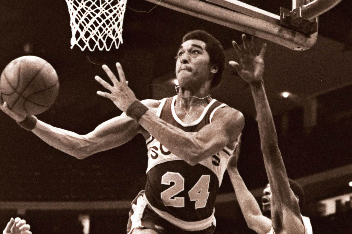 ** FILE ** Seattle SuperSonics' Dennis Johnson (24) soars to the basket past the Chicago Bulls' Mickey Johnson, right, in this March  17, 1979 file photo in Chicago. Johnson, the star NBA guard who was part of three championship teams, died Thursday after collapsing at the end of practice in Austin, Texas. He was 52. Johnson, coach of the Austin Toros of the NBA Development League, died at a hospital, D-League spokesman Kent Partridge said. (AP Photo/Fred Jewell)