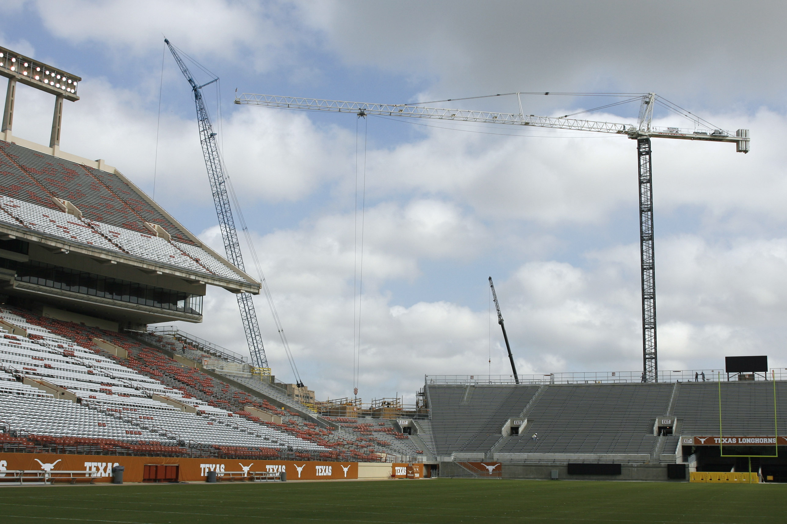 Construction cranes tower over the campus skyline and the unfinished football stands in the north end zone, shown on the right, of Darrell K. Royal-Texas Memorial Stadium as seen Tuesday, Aug. 28, 2007, in Austin, Texas. Texas officials say once it's finished the home of the Longhorns will seat about 90,000 people.  (AP Photo/Harry Cabluck)
