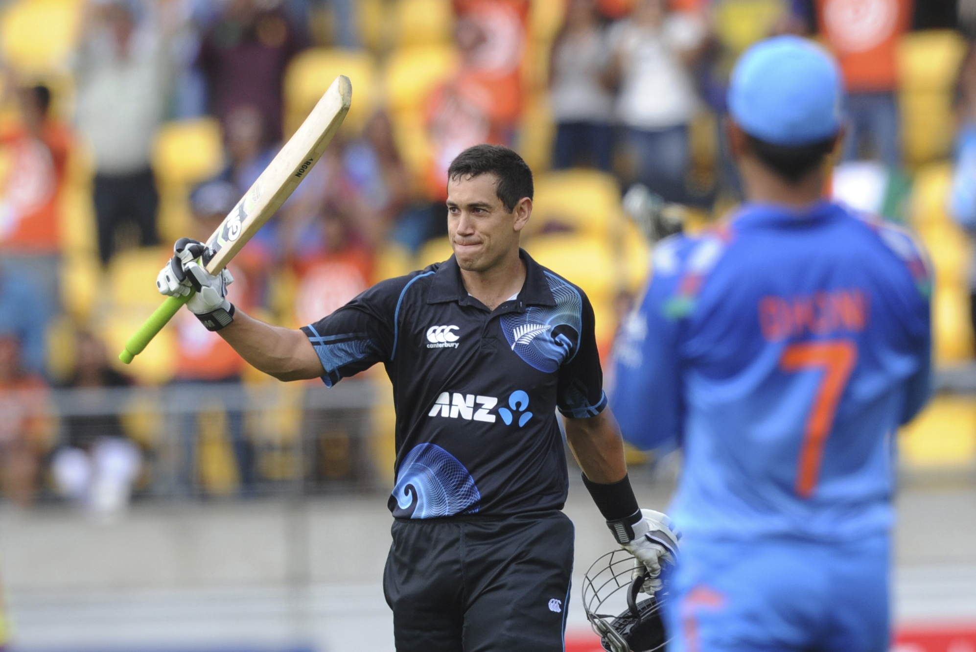 New Zealand's Ross Taylor, left, is applauded by India’s MS Dhoni on reaching his century in the fifth and final one-day international cricket match in Wellington, New Zealand, Friday, Jan. 31, 2014. (AP Photo/SNPA, Ross Setford) NEW ZEALAND OUT