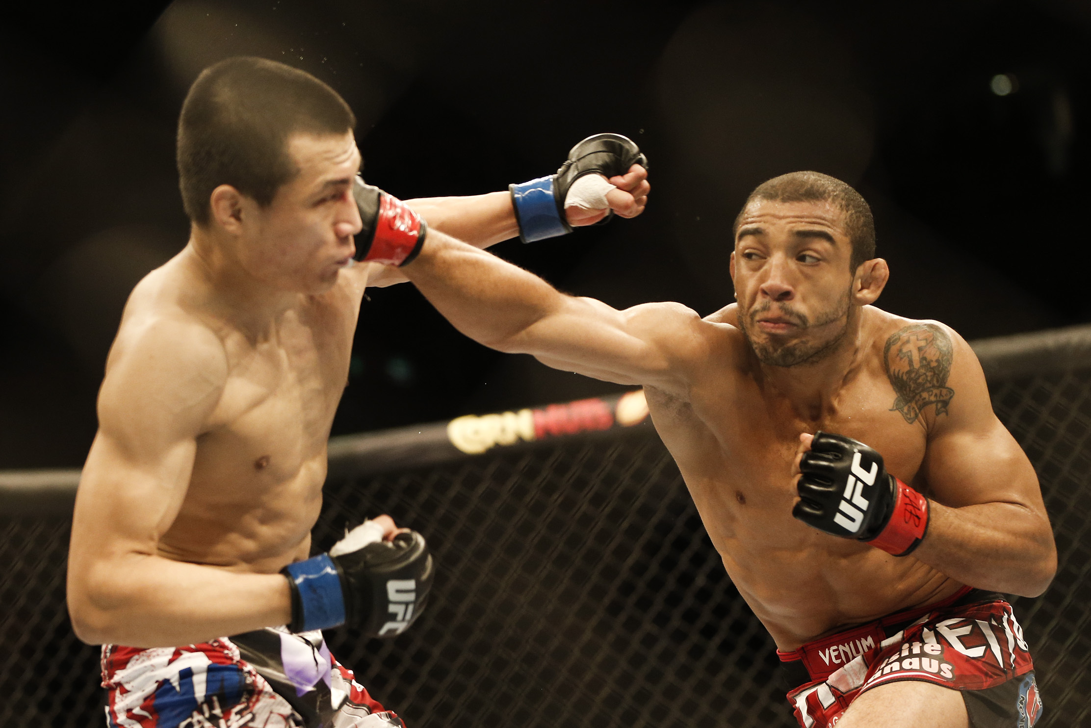 Jose Aldo, from Brazil, right, and Chan Sung Jung, from South Korea, battle during their UFC 163 mixed martial arts Featherweight Championship bout in Rio de Janeiro, Brazil, Sunday, Aug. 4, 2013. Aldo defeated Jung and kept his Championship belt. (AP Photo/Felipe Dana)
