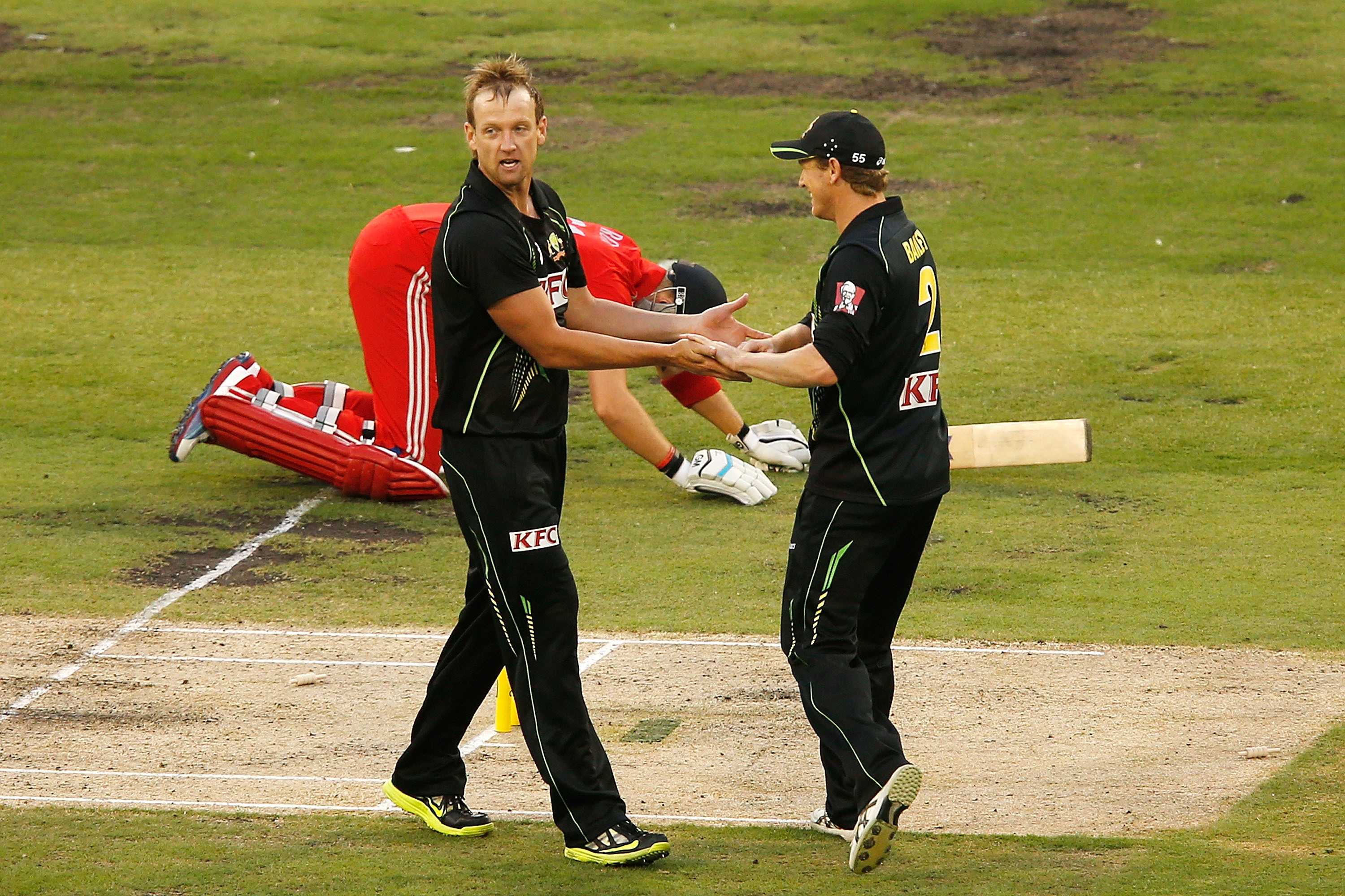 MELBOURNE, AUSTRALIA - JANUARY 31:  Cameron White and George Bailey of Australia celebrate the run out of Joe Root of England during game two of the International Twenty20 series between Australia and England at the Melbourne Cricket Ground on January 31, 2014 in Melbourne, Australia.  (Photo by Darrian Traynor/Getty Images)