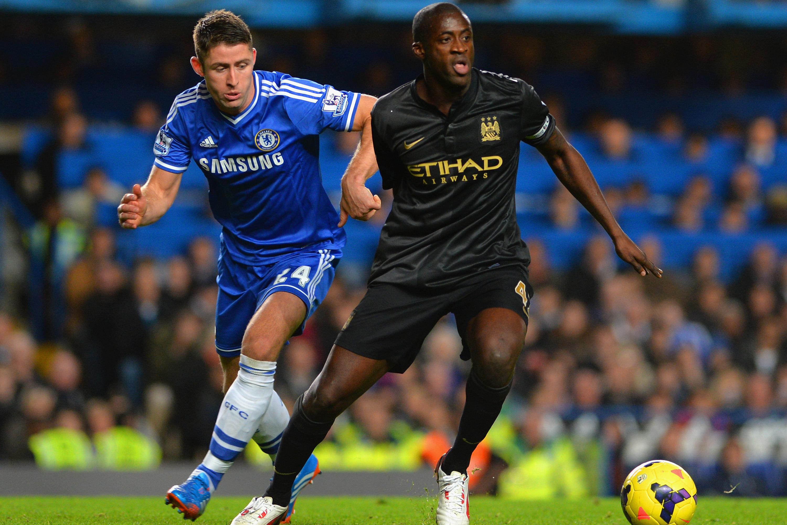 LONDON, ENGLAND - OCTOBER 27:  Gary Cahill of Chelsea and Yaya Toure of Manchester City compete for the bsll during the Barclays Premier League match between Chelsea and Manchester City at Stamford Bridge on October 27, 2013 in London, England.  (Photo by Shaun Botterill/Getty Images)