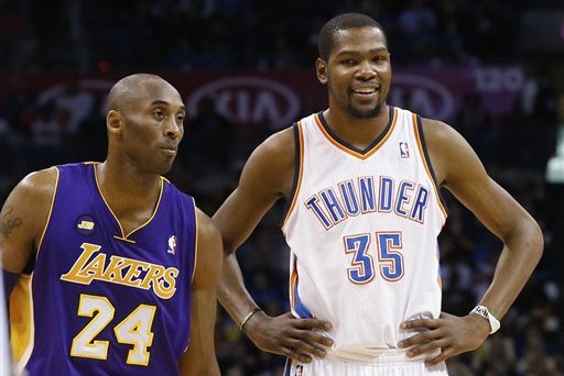 Los Angeles Lakers guard Kobe Bryant (24) and Oklahoma City Thunder forward Kevin Durant (35) talks during a foul shot in the third quarter of an NBA basketball game in Oklahoma City, Tuesday, March 5, 2013. Oklahoma City won 122-105. (AP Photo/Sue Ogrocki)