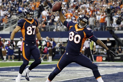 Denver Broncos tight end Julius Thomas (80) celebrates his touchdown against the Dallas Cowboys during the first quarter of an NFL football game Sunday, Oct. 6, 2013, in Arlington, Texas. Eric Decker (87) joins in. (AP Photo/Tony Gutierrez)