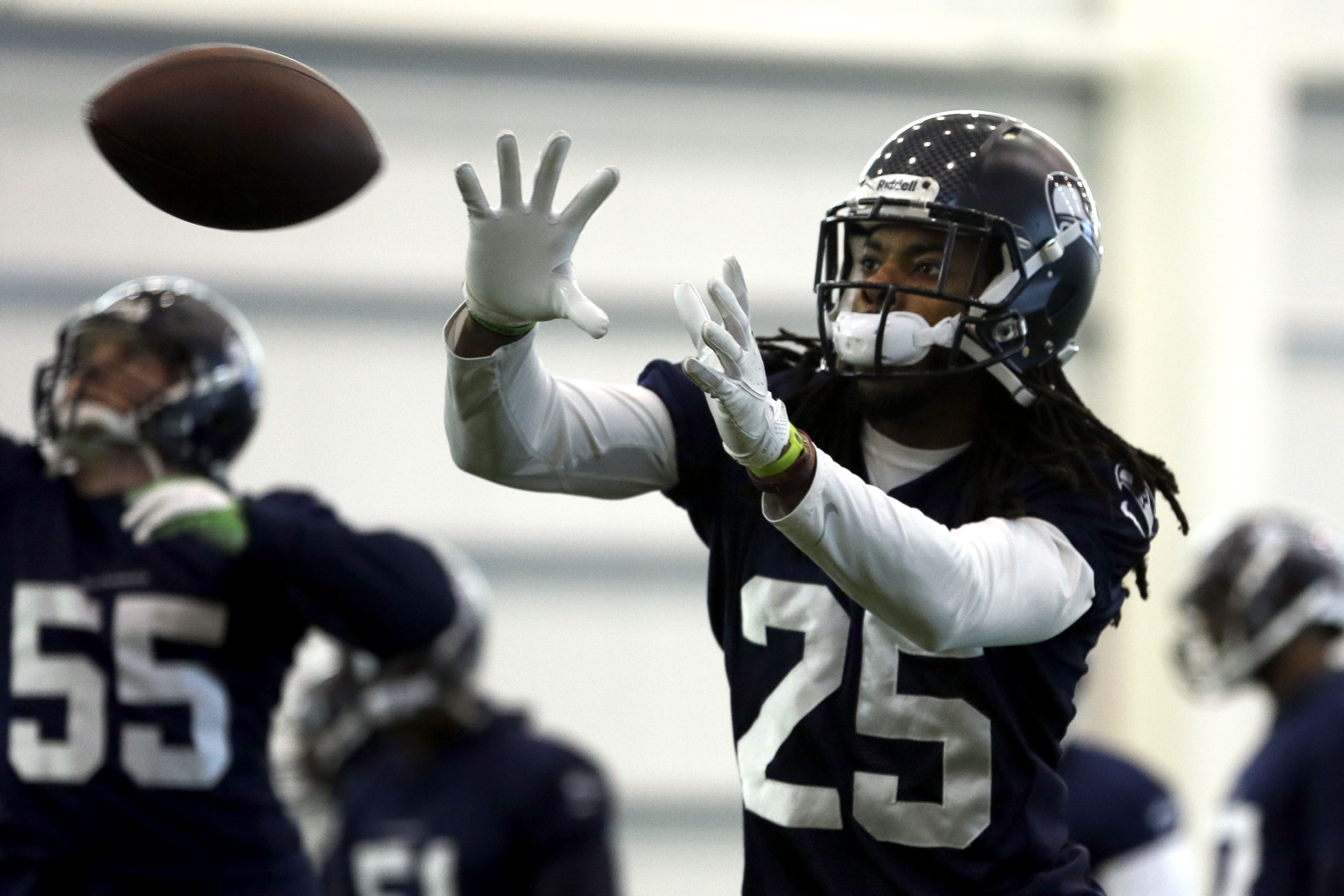 Seattle Seahawks cornerback Richard Sherman catches a ball during NFL football practice Wednesday, Jan. 29, 2014, in East Rutherford, N.J. The Seahawks and the Denver Broncos are scheduled to play in the Super Bowl XLVIII football game Sunday, Feb. 2, 2014. (AP Photo/Jeff Roberson)