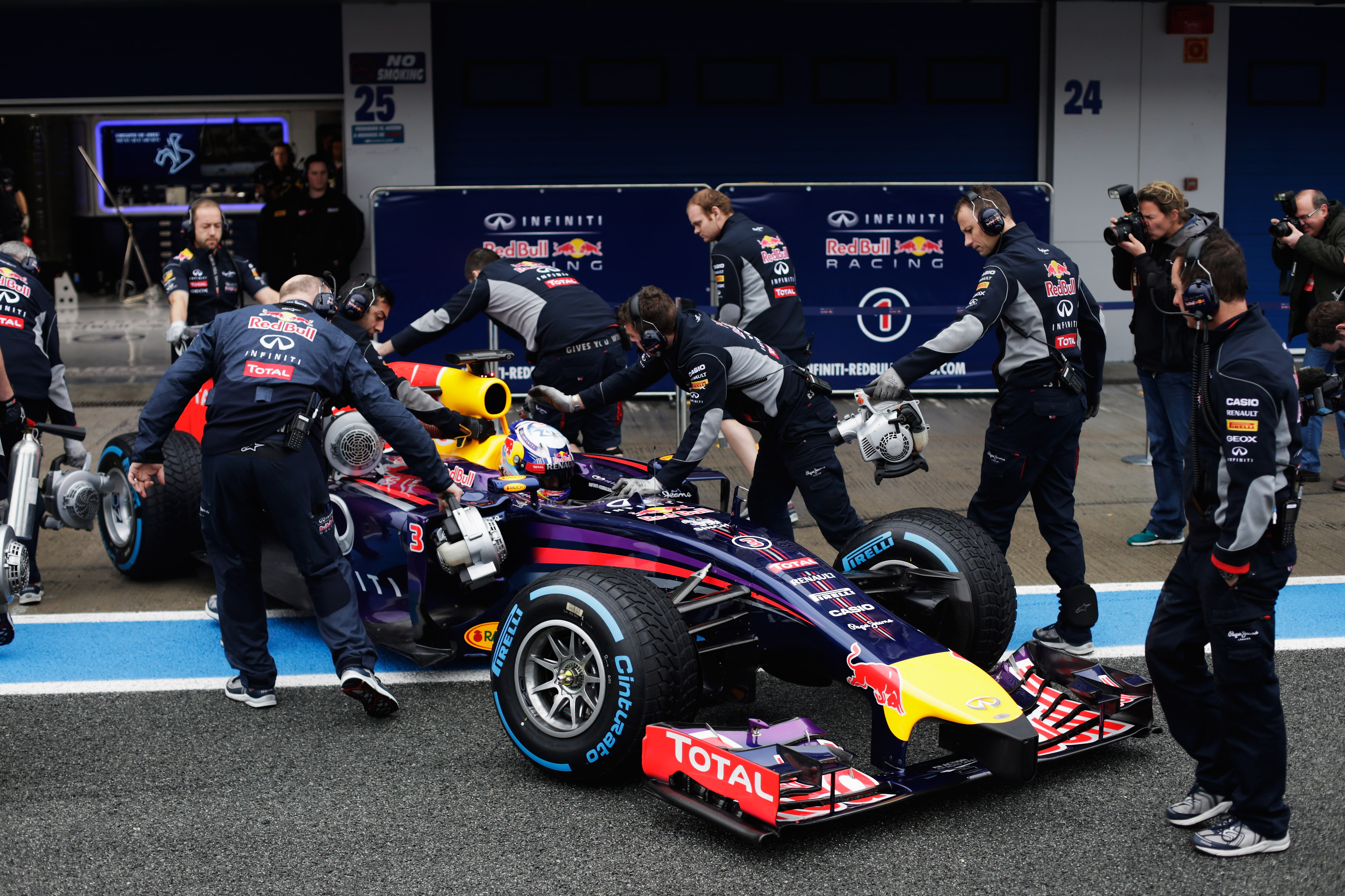 JEREZ DE LA FRONTERA, SPAIN - JANUARY 31:  Daniel Ricciardo of Australia and Infiniti Red Bull Racing is pushed back into his team garage during day four of Formula One Winter Testing at the Circuito de Jerez on January 31, 2014 in Jerez de la Frontera, Spain.  (Photo by Andrew Hone/Getty Images)