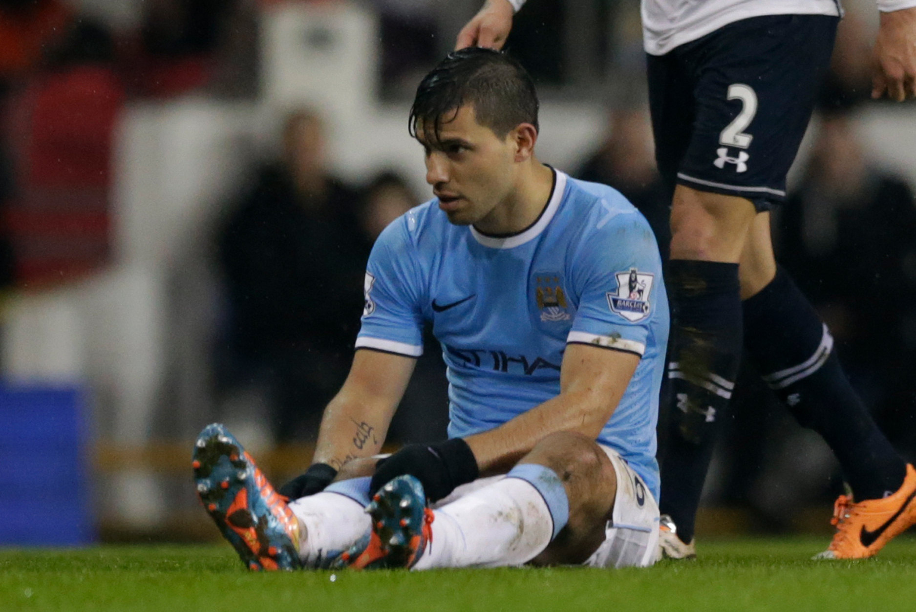 Manchester City's Sergio Aguero sits on the field injured before being substituted off during the English Premier League soccer match between Tottenham Hotspur and Manchester City at White Hart Lane stadium in London, Wednesday, Jan. 29, 2014.  (AP Photo/Matt Dunham)