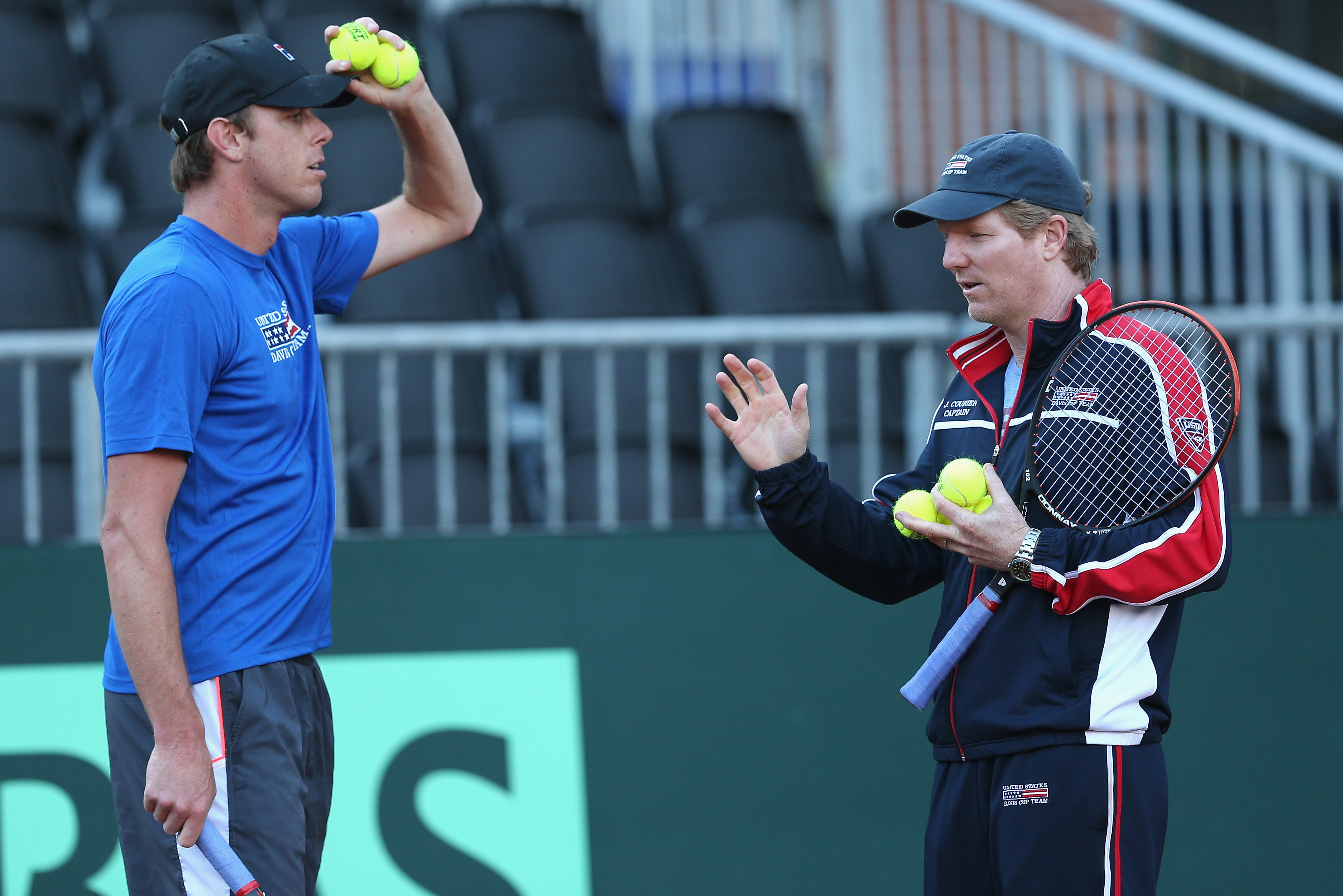 SAN DIEGO, CA - JANUARY 29:  United States captain Jim Courier talks with Sam Querrey during a practice session prior to the Davis Cup World Group first round between the U.S. and Great Britain at PETCO Park on January 29, 2014 in San Diego, California.  (Photo by Clive Brunskill/Getty Images)