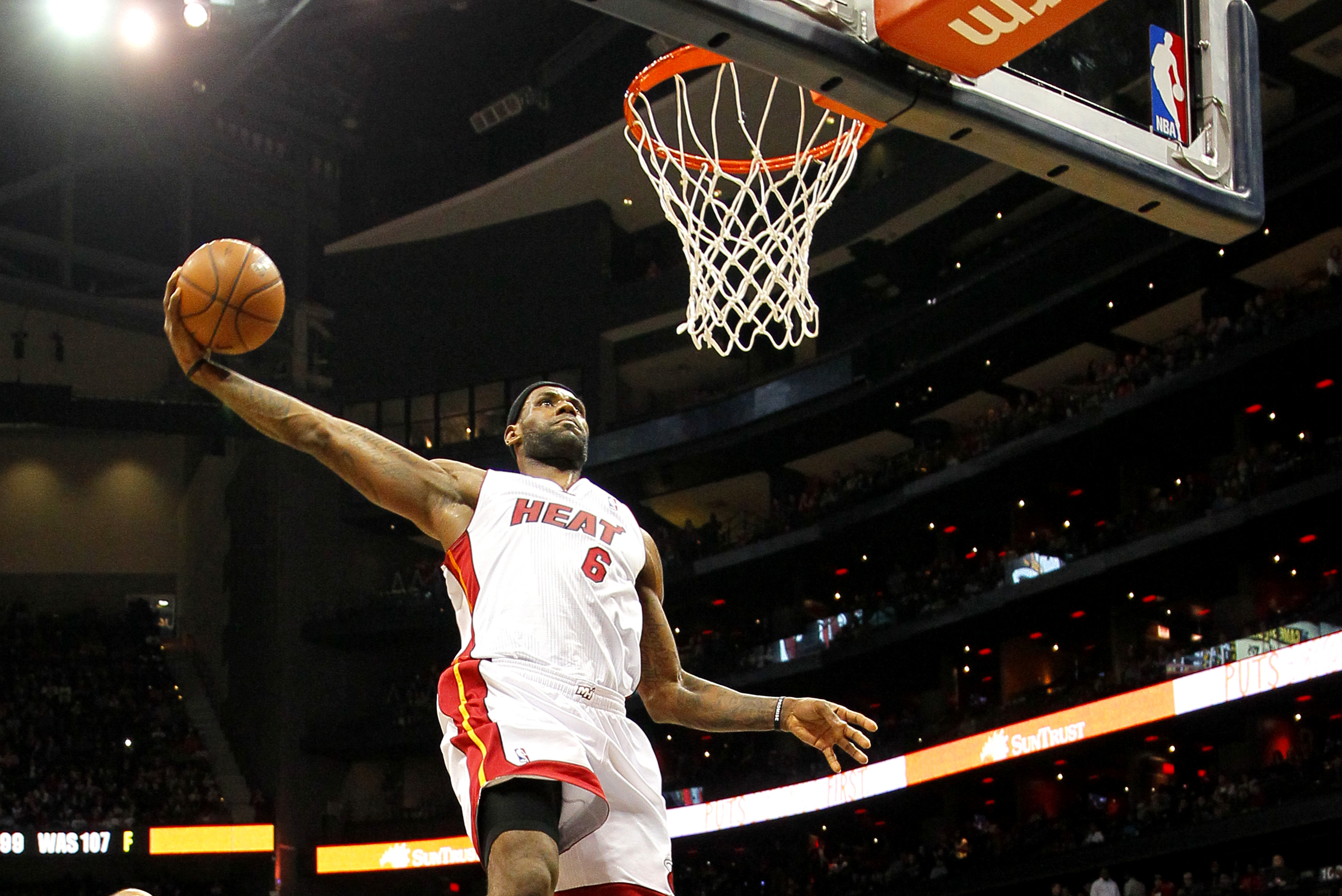 Miami Heat small forward LeBron James (6) dunks in the first period in an NBA basketball game against the Atlanta Hawks in Atlanta, Monday, Jan. 20, 2014. (AP Photo/Todd Kirkland)
