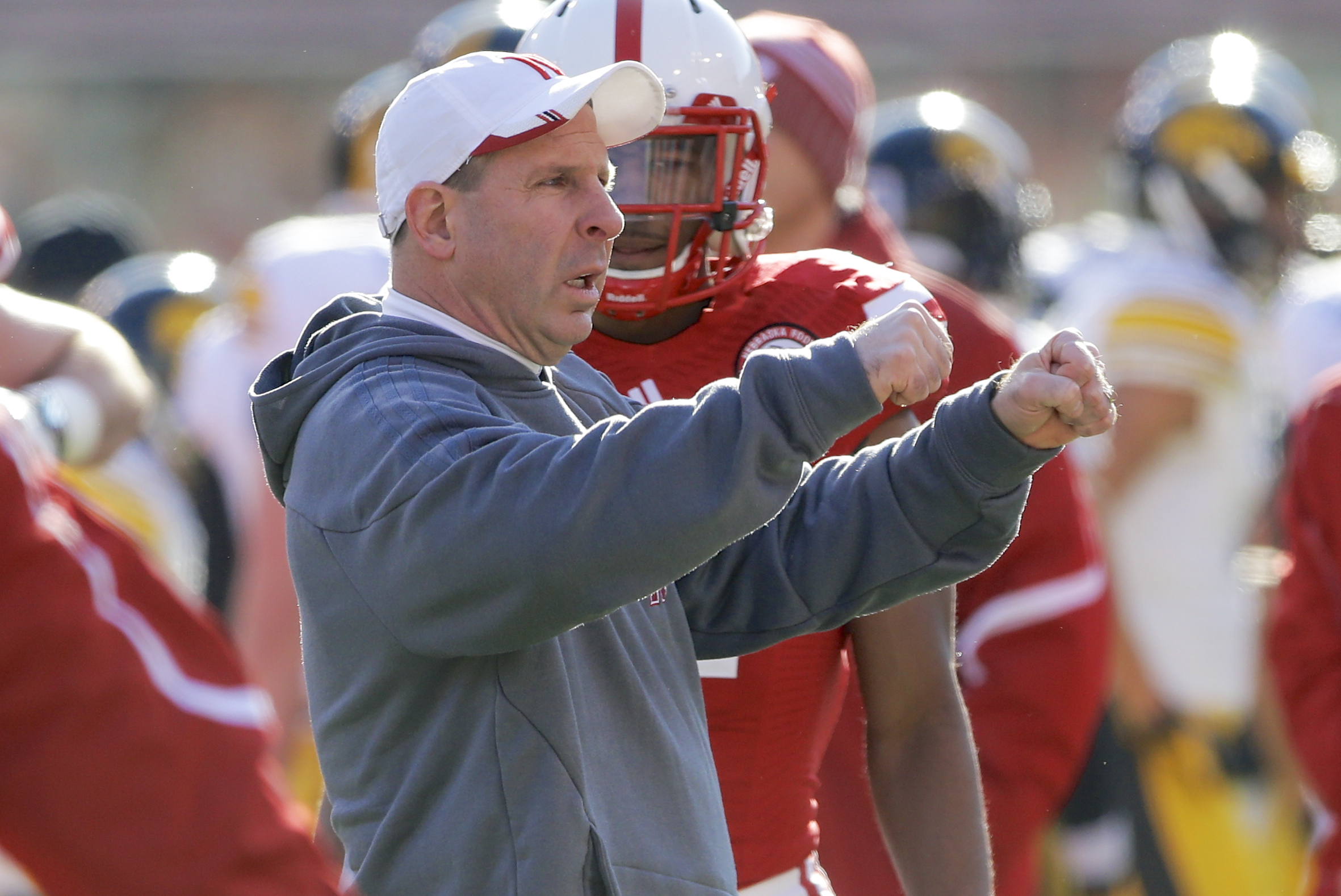 Nebraska head coach Bo Pelini visits with players during warmups as Iowa and Nebraska prepare to square off in an NCAA college football game in Lincoln, Neb., Friday, Nov. 29, 2013. (AP Photo/Nati Harnik)