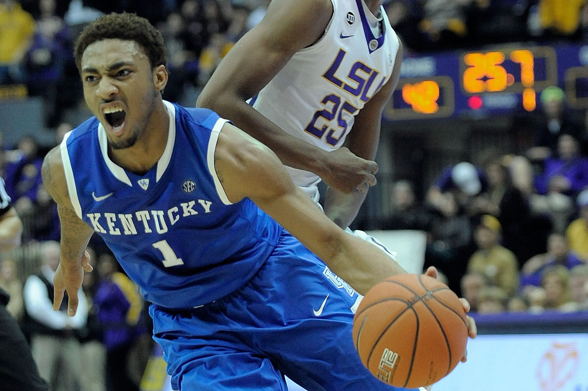BATON ROUGE, LA - JANUARY 28:  James Young #1 of the Kentucky Wildcats is fouled by Jordan Mickey #25 of the LSU Tigers during a game at the Pete Maravich Assembly Center on January 28, 2014 in Baton Rouge, Louisiana.  LSU won the game 87-82.  (Photo by Stacy Revere/Getty Images)