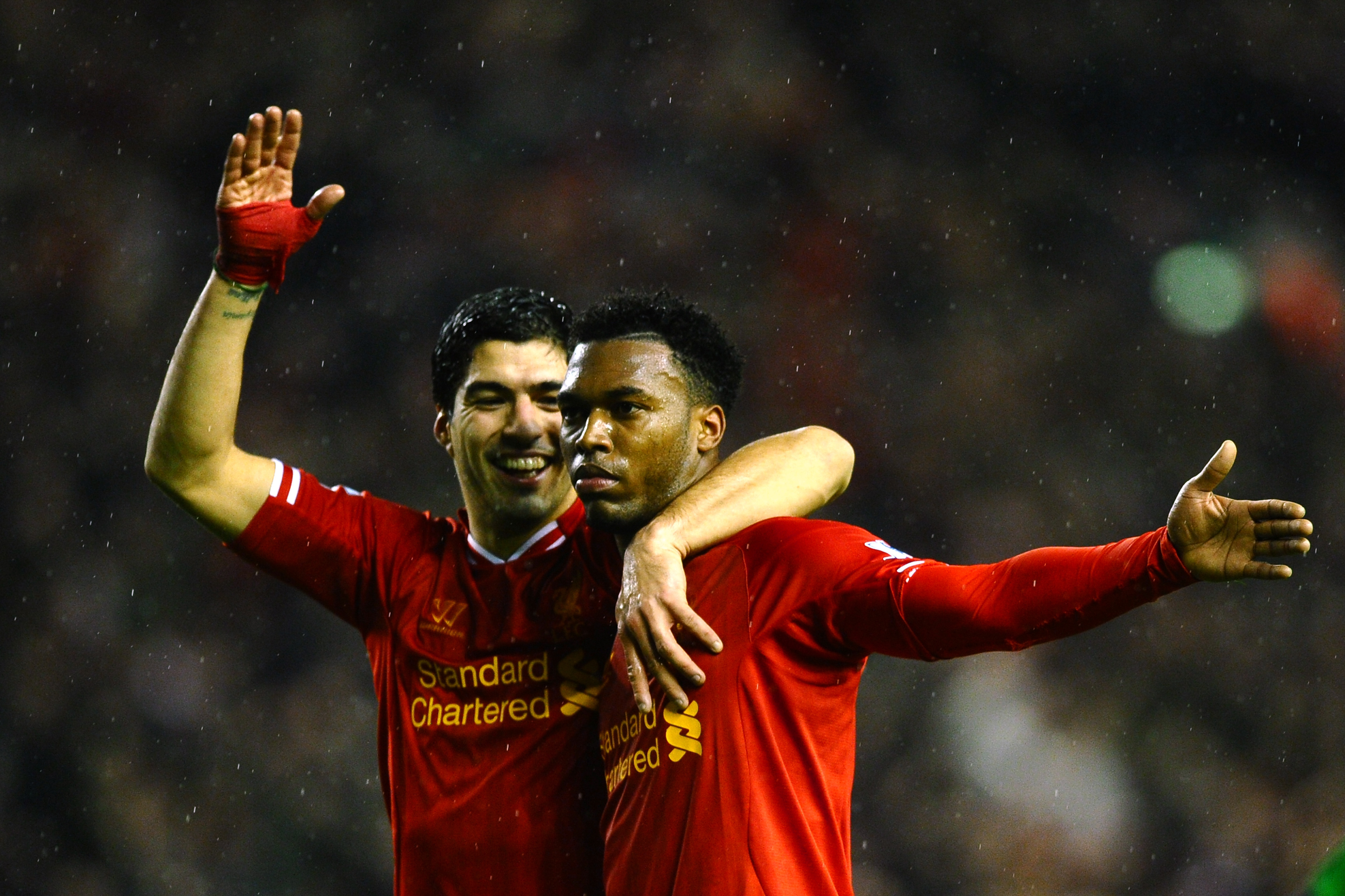 LIVERPOOL, ENGLAND - JANUARY 28:  Daniel Sturridge (R) of Liverpool is congratulated by teammate Luis Suarez (L) after scoring his team's third goal during the Barclays Premier League match between Liverpool and Everton at Anfield on January 28, 2014 in Liverpool, England.  (Photo by Laurence Griffiths/Getty Images)
