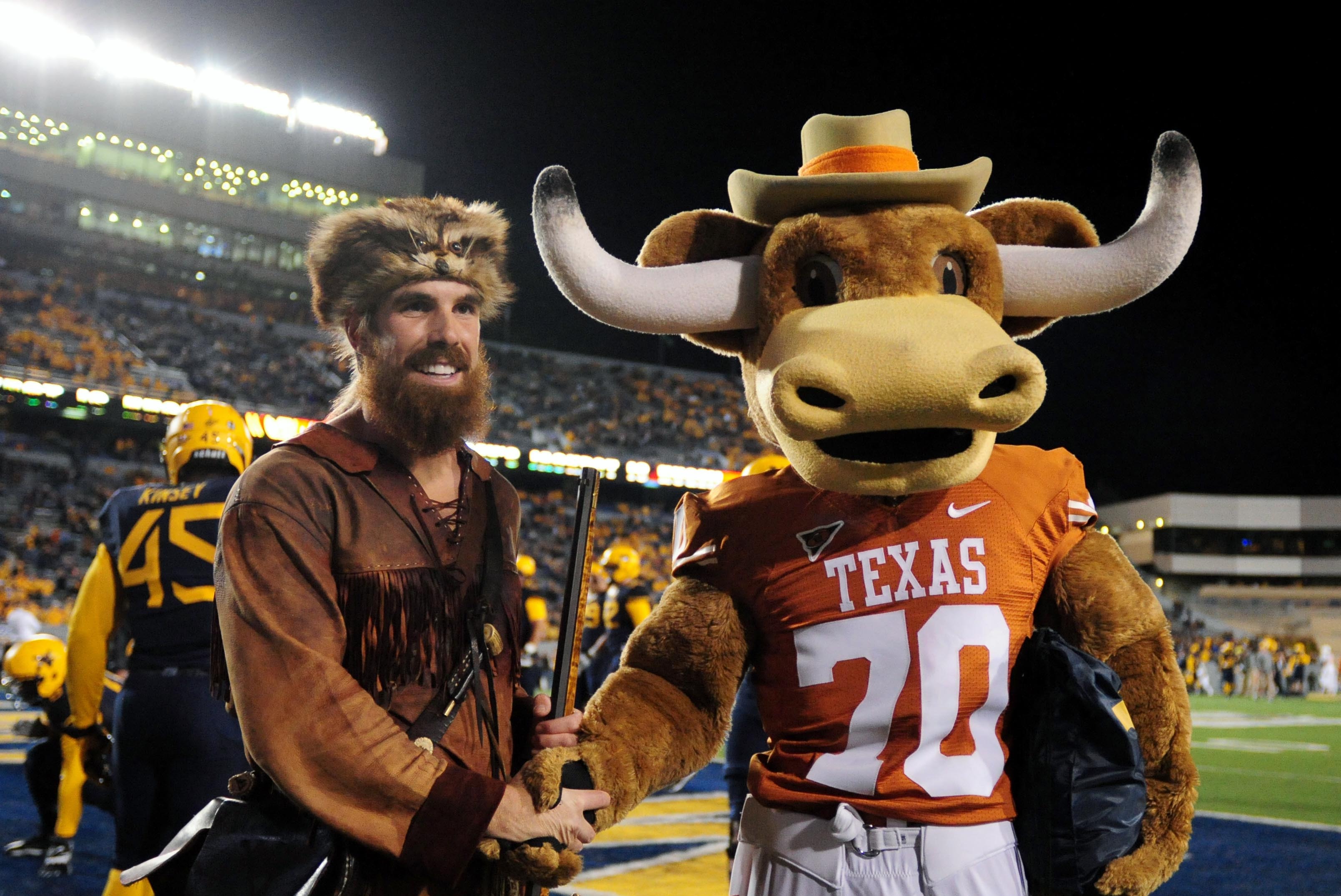 Nov 9, 2013; Morgantown, WV, USA; Mascots for the Texas Longhorns and West Virginia Mountaineers shake hands prior to the game at Milan Puskar Stadium. Mandatory Credit: Evan Habeeb-USA TODAY Sports