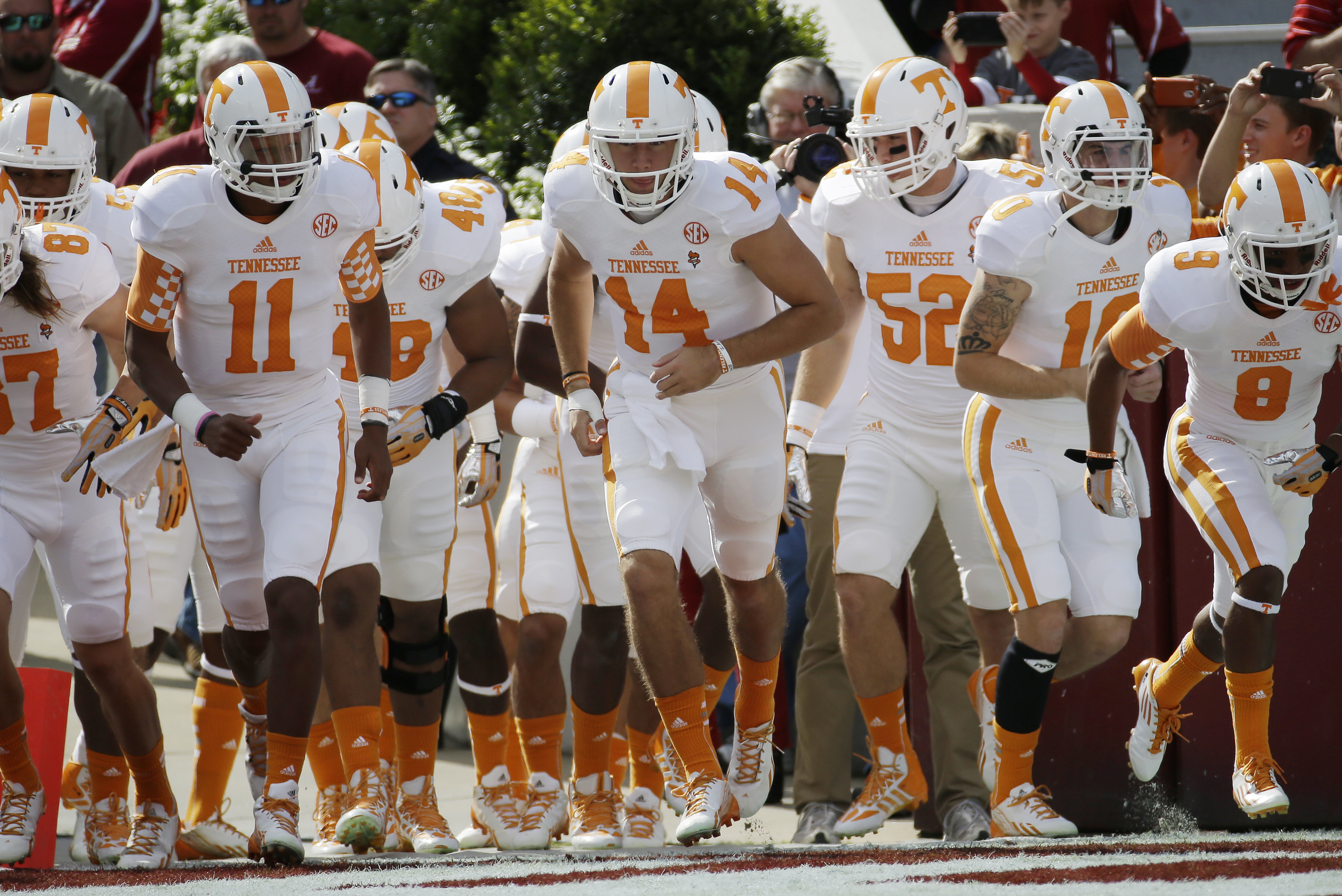 Tennessee quarterback Justin Worley (14) leads the Volunteers onto the field prior to an NCAA college football game against Alabama in Tuscaloosa, Ala., Saturday, Oct. 26, 2013. (AP Photo/Dave Martin)