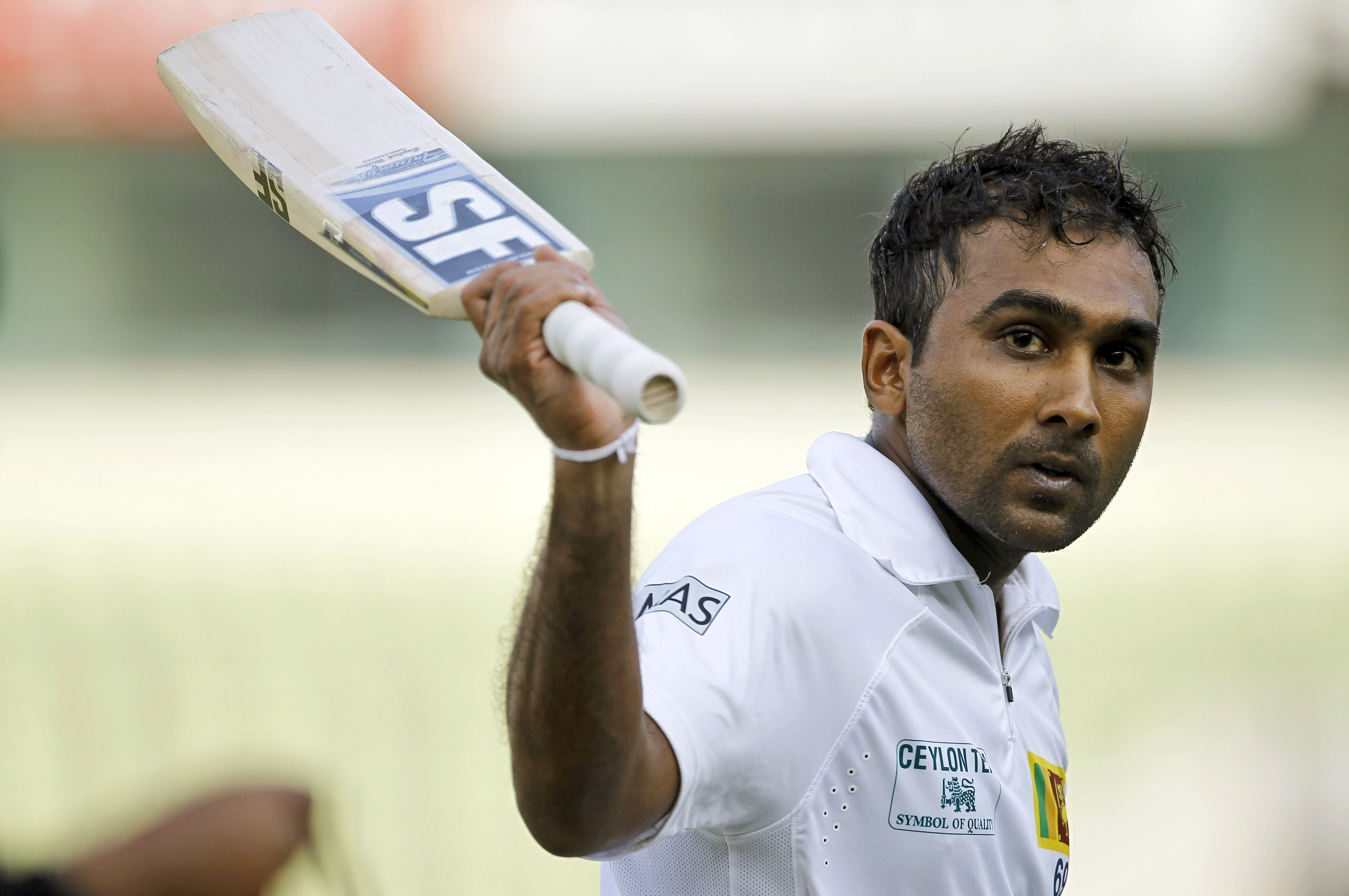 Sri Lankan cricket player Mahela Jayawardene acknowledges the crowd after scoring a double century on the third day of the first test cricket match against Bangladesh in Dhaka, Bangladesh, Wednesday, Jan. 29, 2014. (AP Photo/A.M. Ahad)