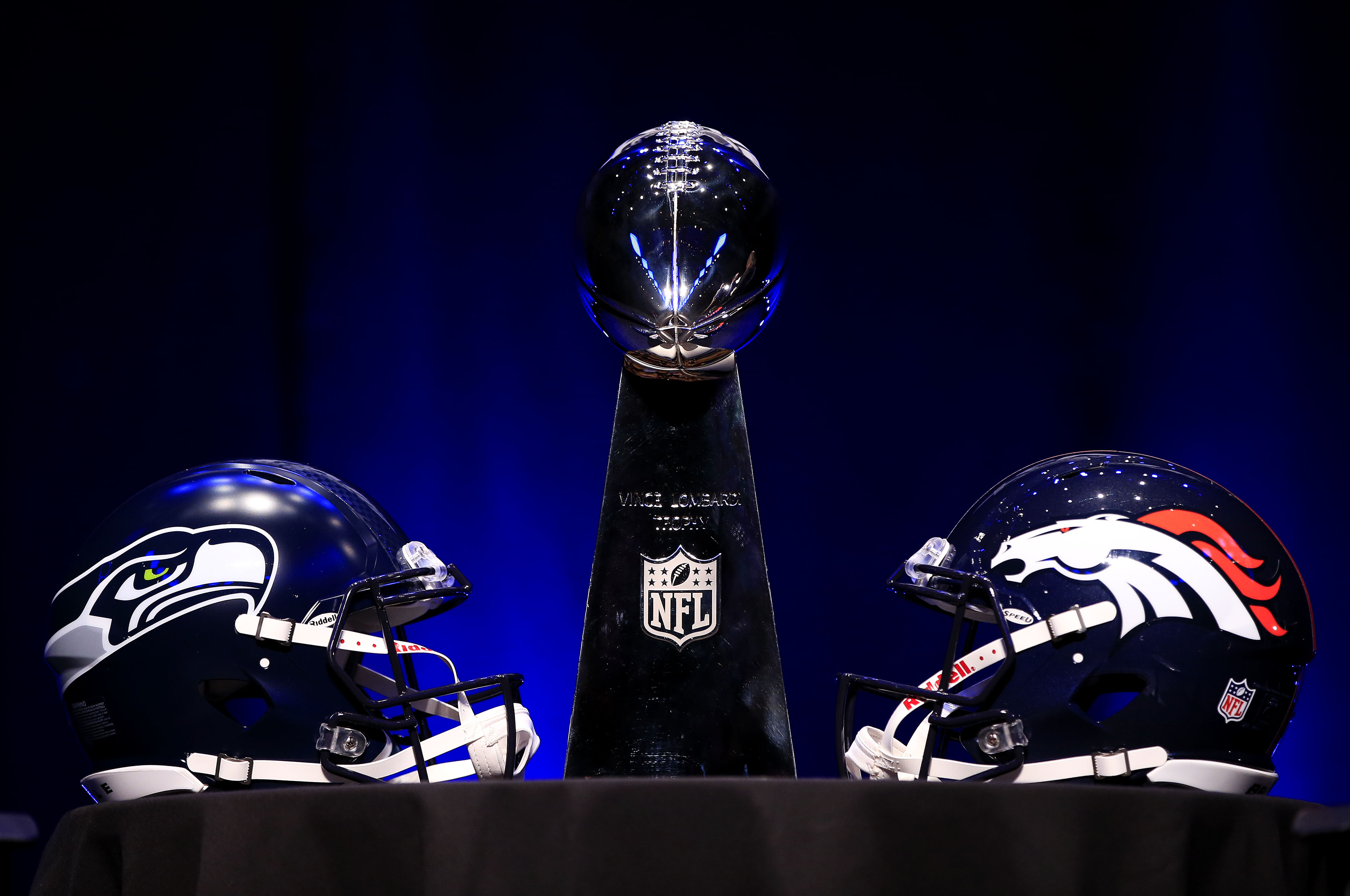 NEW YORK, NY - JANUARY 31:  The Vince Lombardi Trophy and helmets for the Denver Broncos and the Seattle Seahawks are displayed prior to a Super Bowl XLVIII head coach joint press conference at the Rose Theater in Jazz at Lincoln Center on January 31, 2014 in New York City.  (Photo by Jamie Squire/Getty Images)