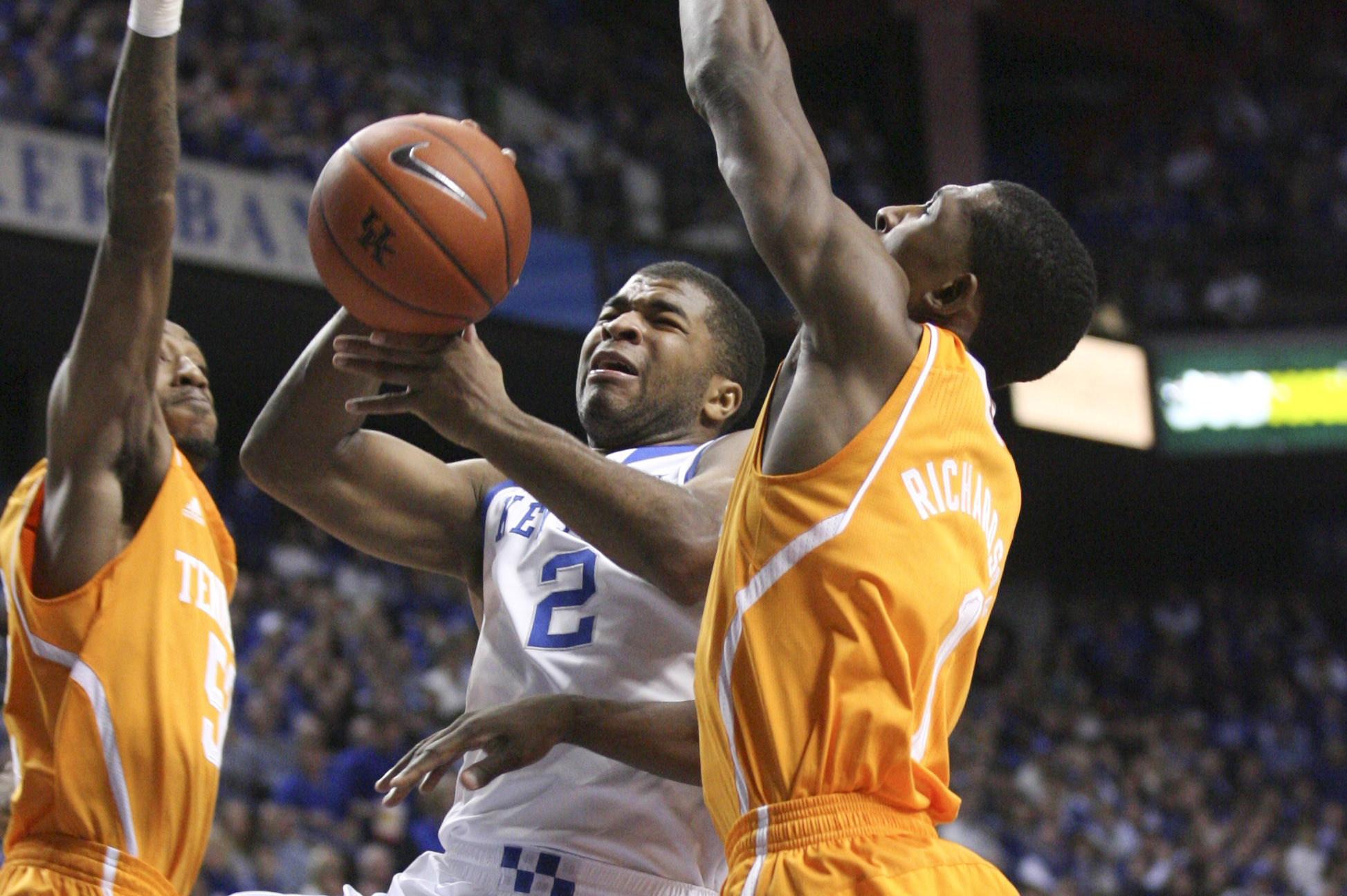 Jan 18, 2014; Lexington, KY, USA; Kentucky Wildcats guard Aaron Harrison (2) shoots the ball against Tennessee Volunteers guard Josh Richardson (1) and forward Jarnell Stokes (5) in the second half at Rupp Arena. Kentucky Wildcats defeated Tennessee 74-66. Mandatory Credit: Mark Zerof-USA TODAY Sports