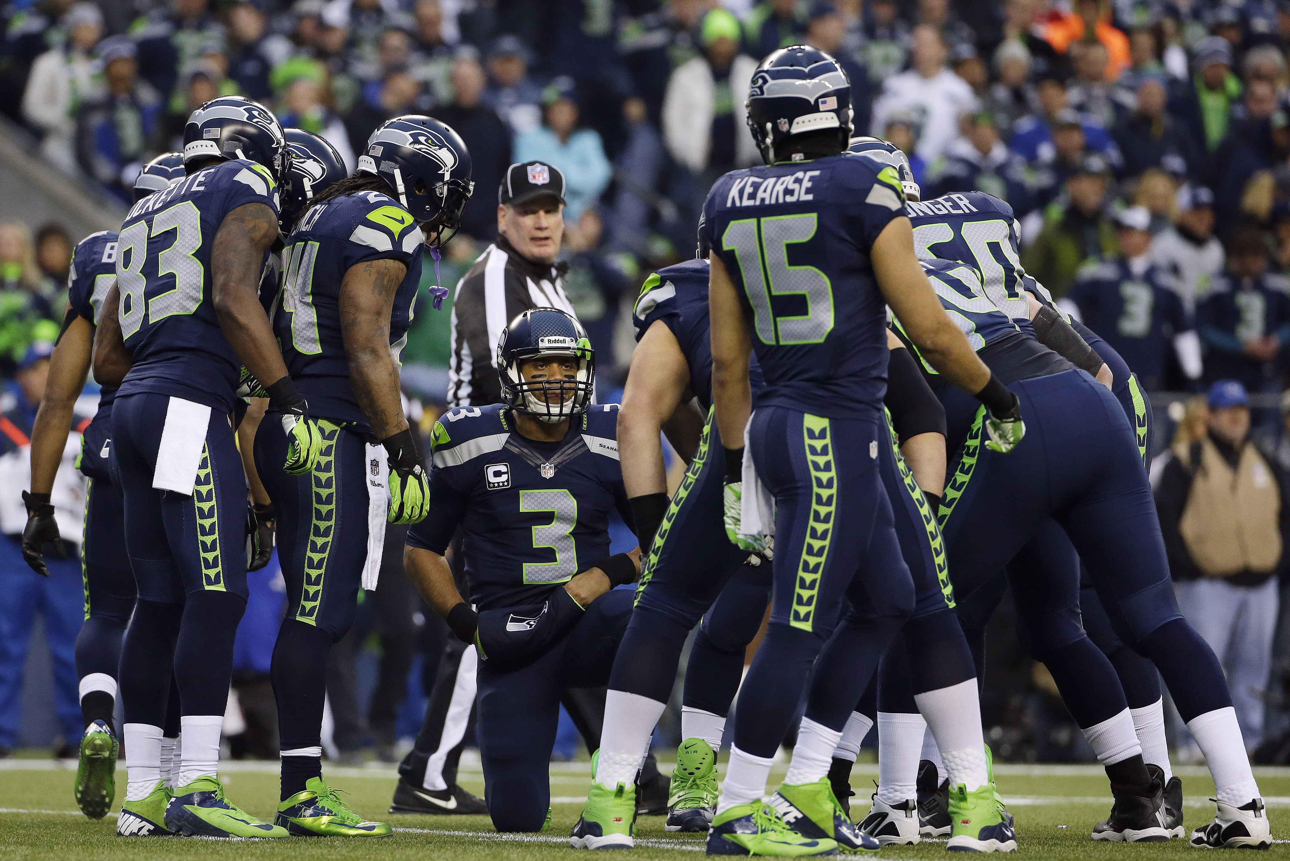 FILE - In this Jan. 19, 2014, file photo, Seattle Seahawks' Russell Wilson (3) speaks to his teammates, including receivers Ricardo Lockette (83) and Jermaine Kearse (15), during huddle in the first half of the NFC championship NFL football game against the San Francisco 49ers in Seattle. It's an unheralded group that have been catching passes from Wilson all season. They despise being cast as Seattle's weak link, but are happy to use those slights as motivation.  (AP Photo/Matt Slocum, File)