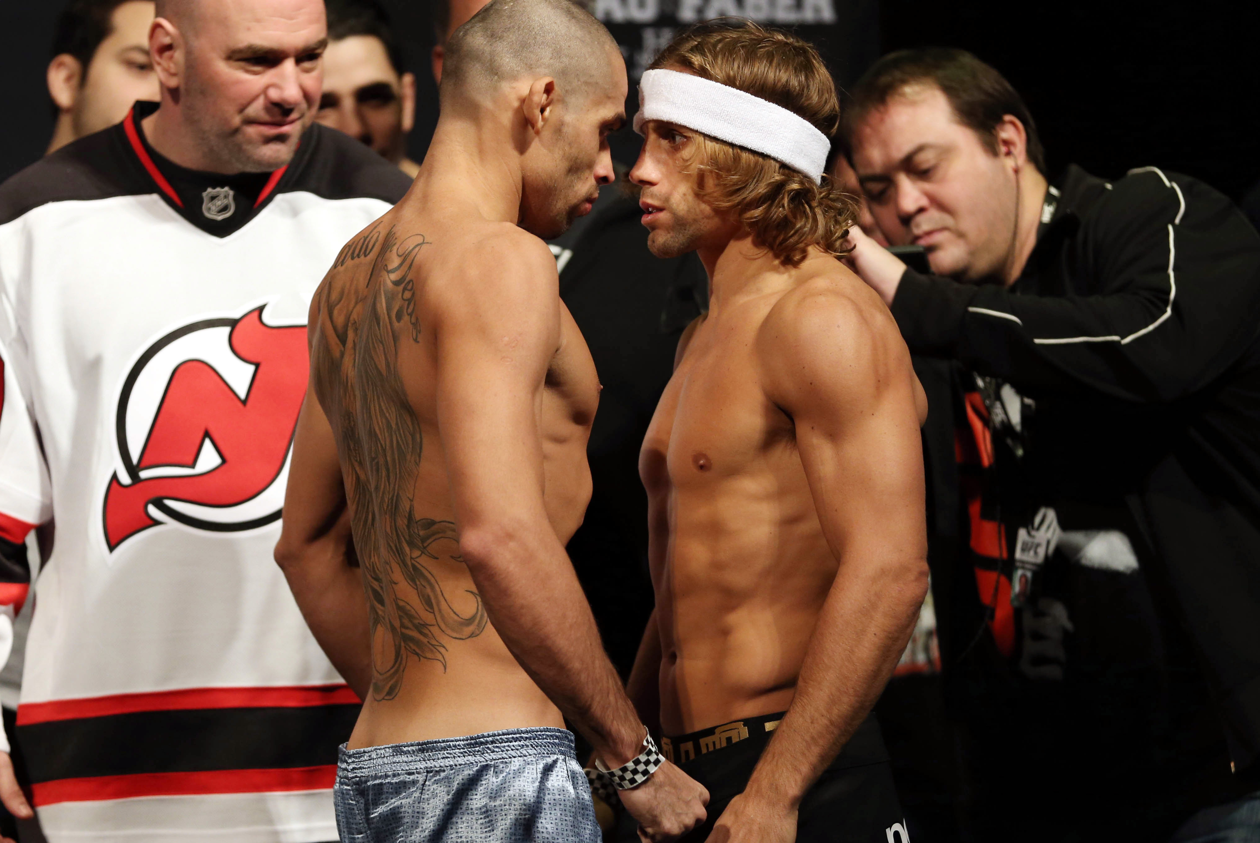 Jan 31, 2014; Newark, NJ, USA; Urijah Faber (right) and Renan Barao (left) face off after weighing in for their Bantamweight Championship bout at Prudential Center. Mandatory Credit: Joe Camporeale-USA TODAY Sports