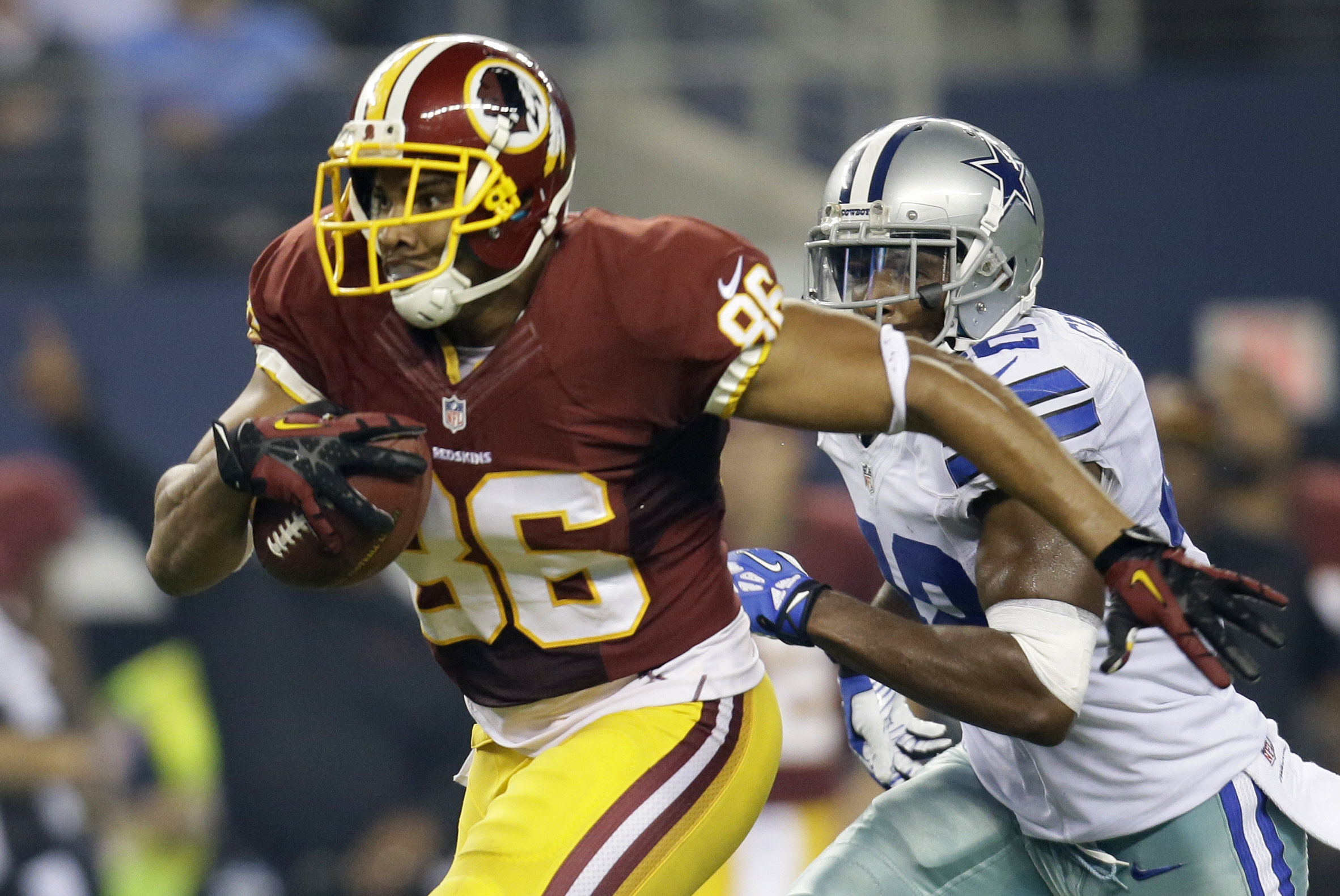 Washington Redskins tight end Jordan Reed (86) finds running room after grabbing a pass from quarterback Robert Griffin III as Dallas Cowboys free safety Barry Church (42) gives chase in the first half of an NFL football game, Sunday, Oct. 13, 2013, in Arlington, Texas.(AP Photo/Tim Sharp)
