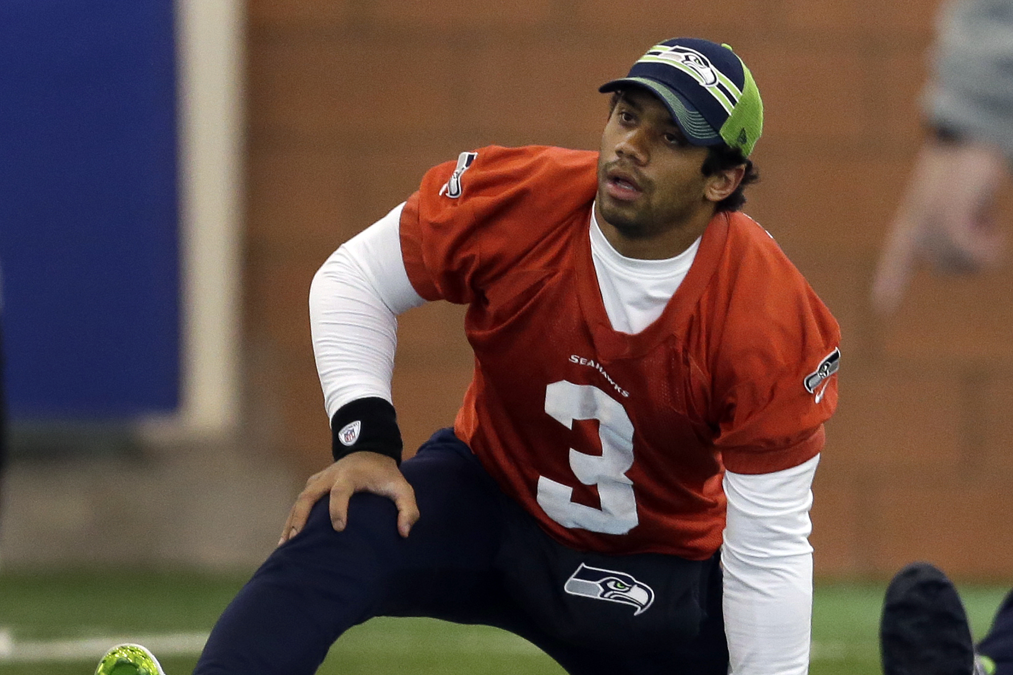 Seattle Seahawks quarterback Russell Wilson stretches at the start of NFL football practice Friday, Jan. 31, 2014, in East Rutherford, N.J. The Seahawks and the Denver Broncos are scheduled to play in the Super Bowl XLVIII football game Sunday, Feb. 2, 2014. (AP Photo/Jeff Roberson)