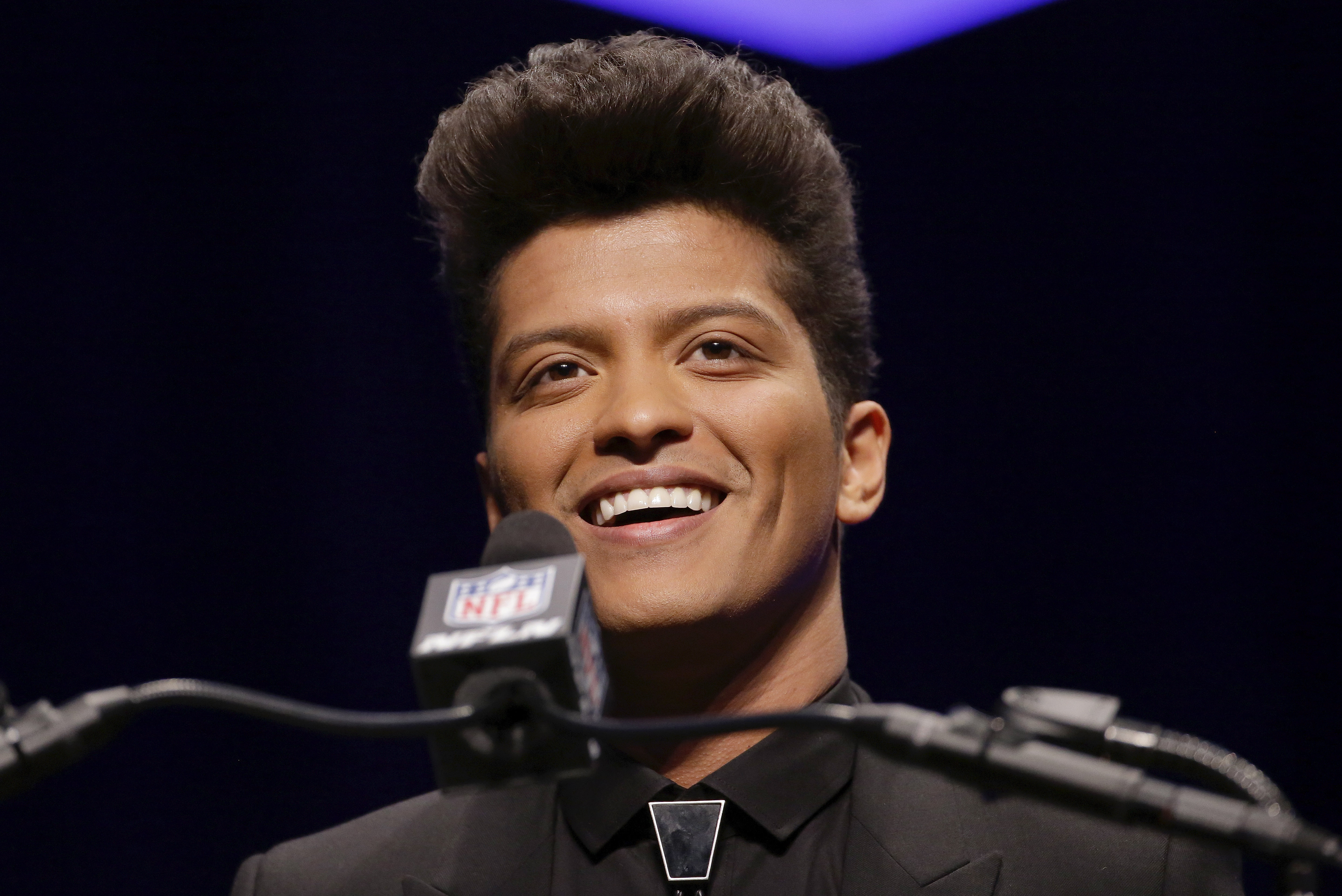 Bruno Mars who will headline the half-time show at the NFL Super Bowl XLVIII football game speaks during a press conference Thursday, Jan. 30, 2014, in New York. (AP Photo)