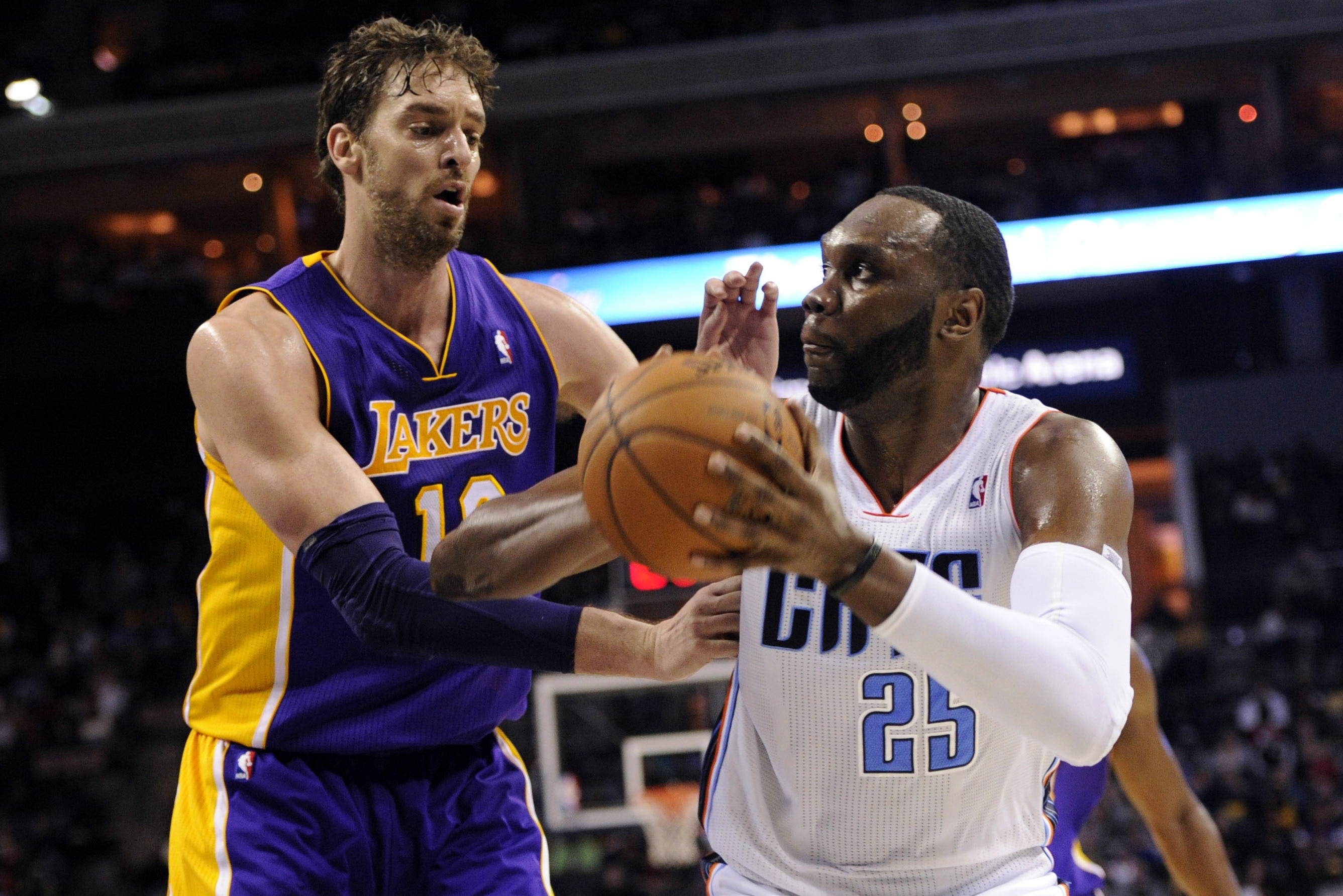 Dec 14, 2013; Charlotte, NC, USA; Charlotte Bobcats center Al Jefferson (25) looks to shoot as he is defended by Los Angeles Lakers center forward Pau Gasol (16) during the second half of the game at Time Warner Cable Arena. Lakers win 88-85.  Mandatory Credit: Sam Sharpe-USA TODAY Sports