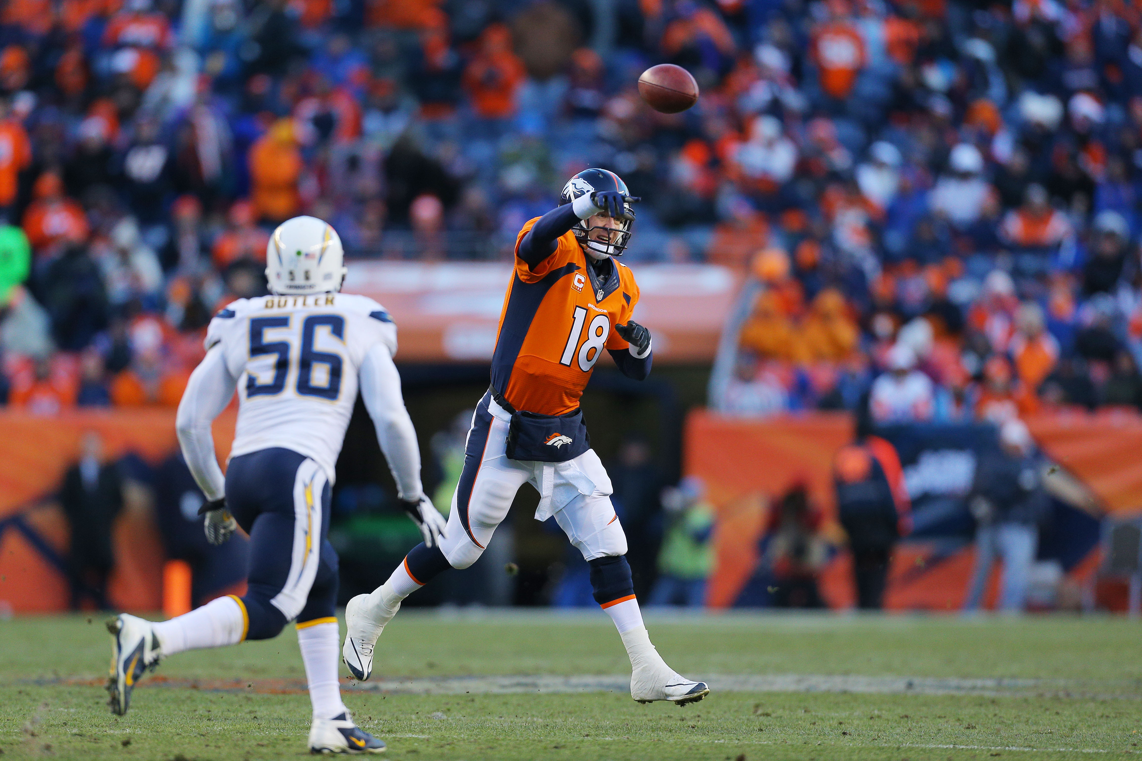 DENVER, CO - JANUARY 12:   Peyton Manning #18 of the Denver Broncos throws a pass against the San Diego Chargers during the AFC Divisional Playoff Game at Sports Authority Field at Mile High on January 12, 2014 in Denver, Colorado.  (Photo by Justin Edmonds/Getty Images)