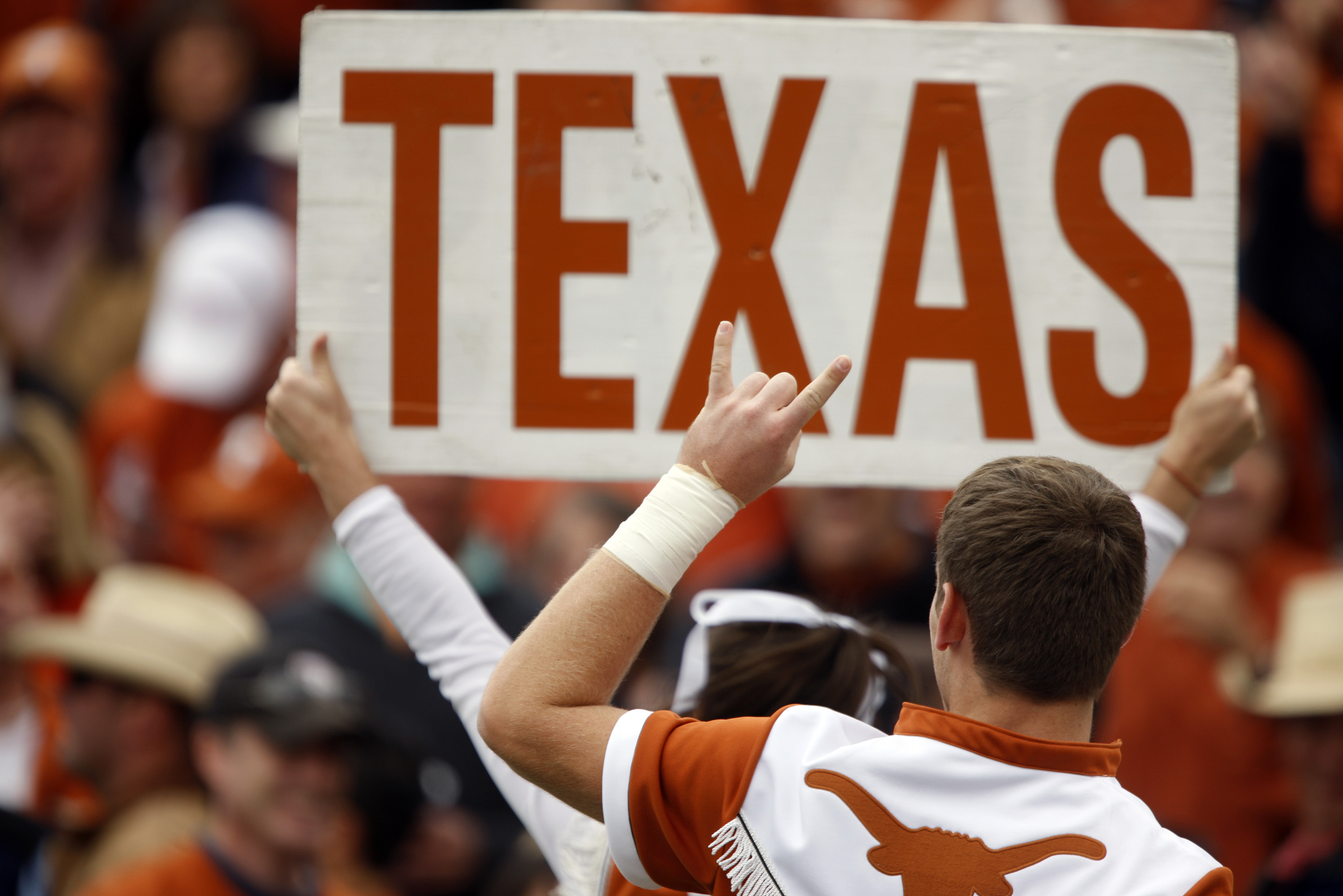 Texas cheerleaders lead fans as the Longhorns face Wyoming in the first quarter of an NCAA college football game in Laramie, Wyo., on Saturday, Sept. 12, 2009. (AP Photo/David Zalubowski)