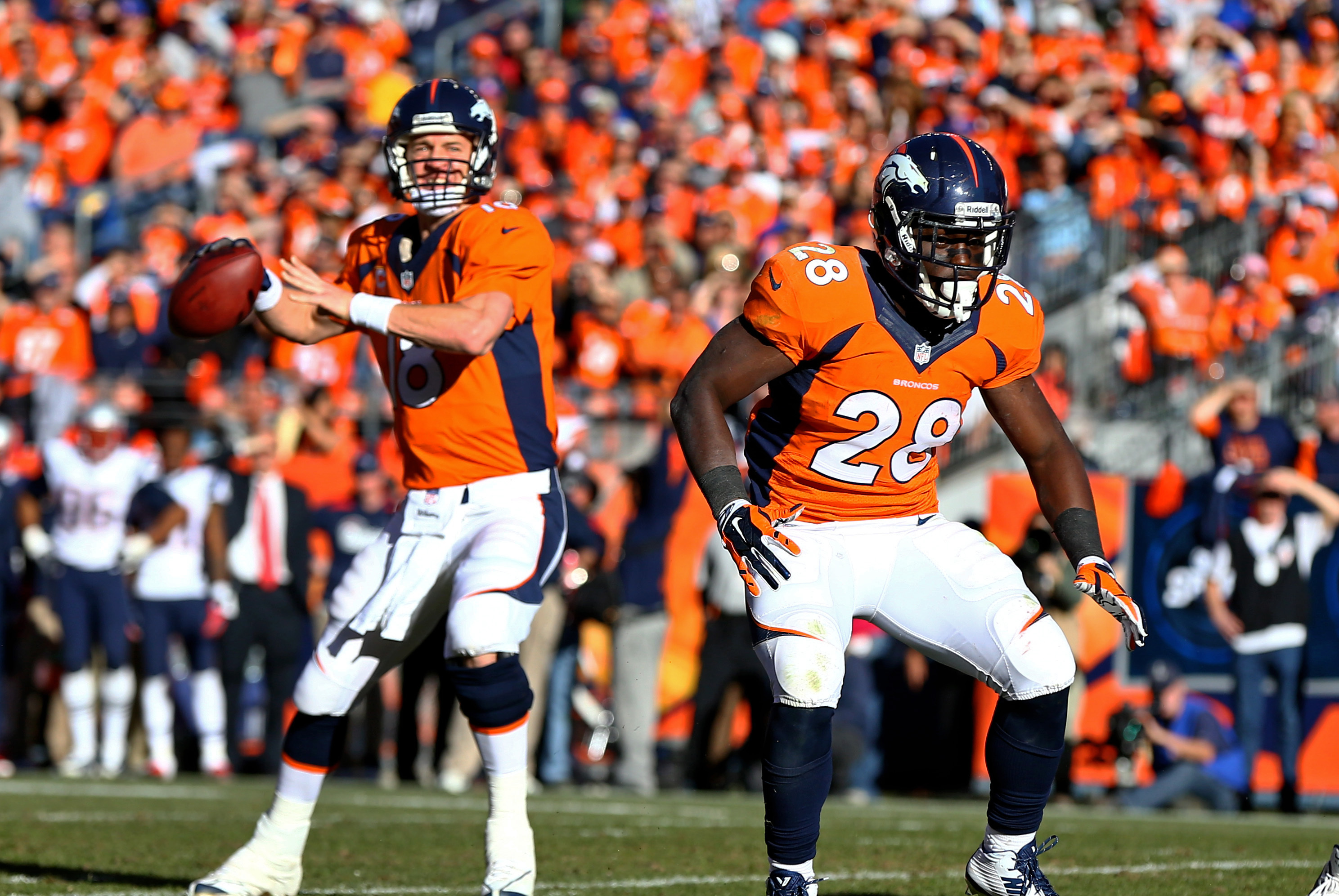 Jan 19, 2014; Denver, CO, USA; Denver Broncos running back Montee Ball (28) blocks for quarterback Peyton Manning (18) against the New England Patriots during the 2013 AFC Championship football game at Sports Authority Field at Mile High. Mandatory Credit: Mark J. Rebilas-USA TODAY Sports