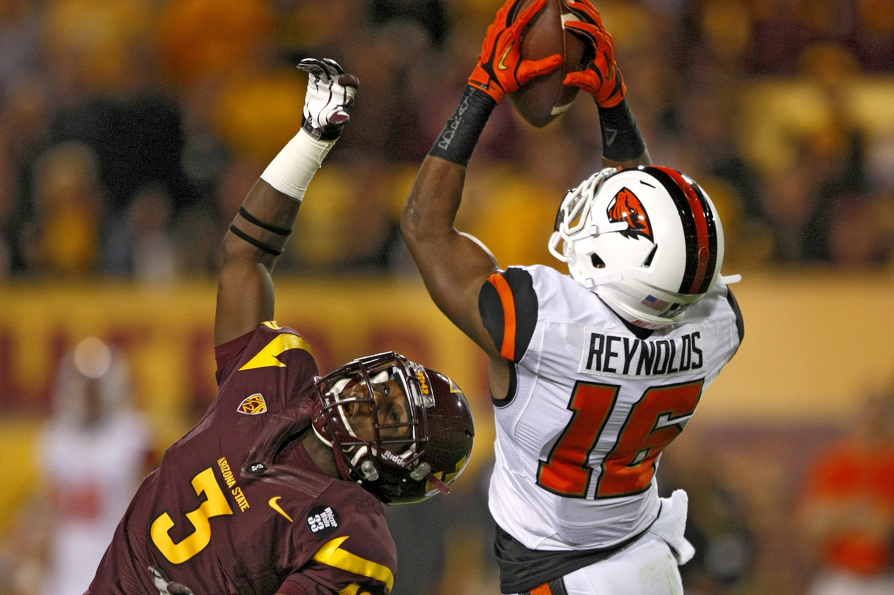 Oregon State cornerback Rashaad Reynolds (16) intercepts the ball in front of Arizona State wide receiver Richard Smith (3) during the first half of an NCAA college football game on Saturday, Nov. 16, 2013, in Tempe, Ariz. (AP Photo/Rick Scuteri)